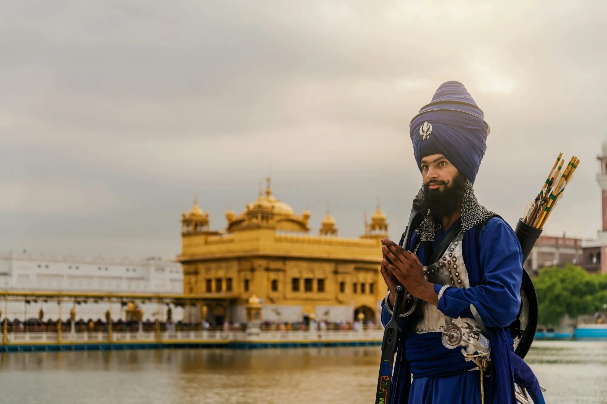 A Nihang in a blue turban before the Golden Temple