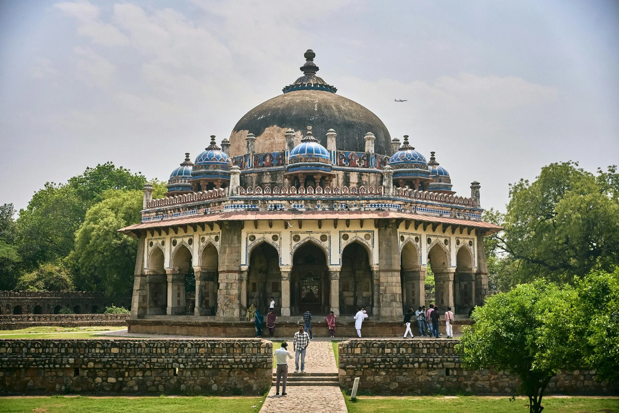 A domed Mughal tomb among trees