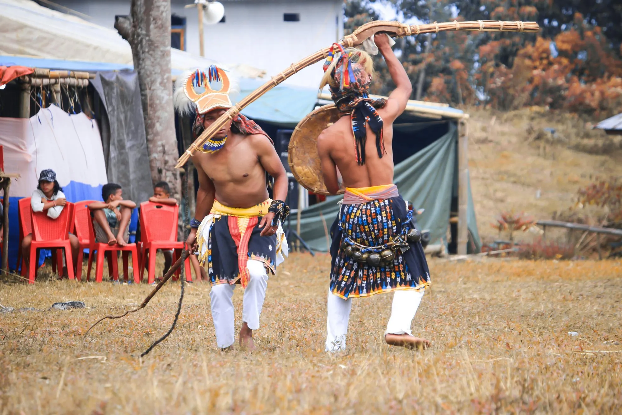 Two Naga dancers with spear and shield on the festival ground