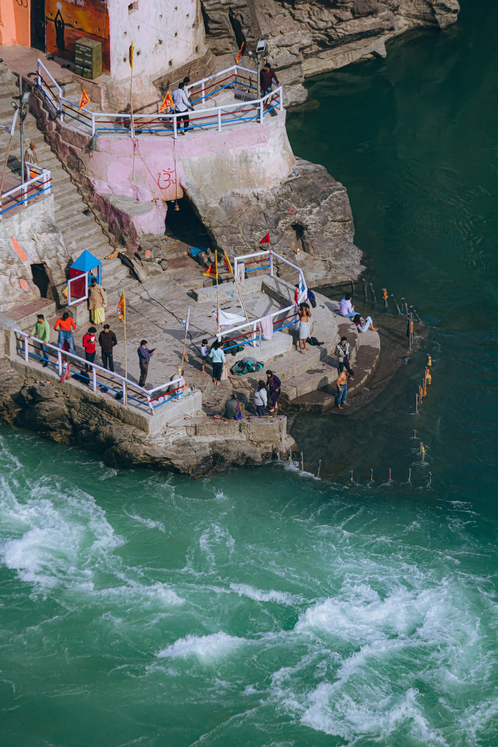 Bathers on the steps of a ghat above the green Ganga, Rishikesh