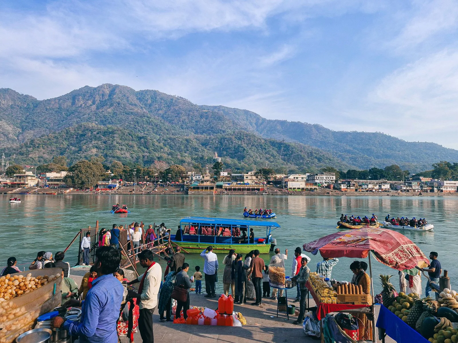 The riverfront at Rishikesh: stalls, ferry boats and the hills beyond