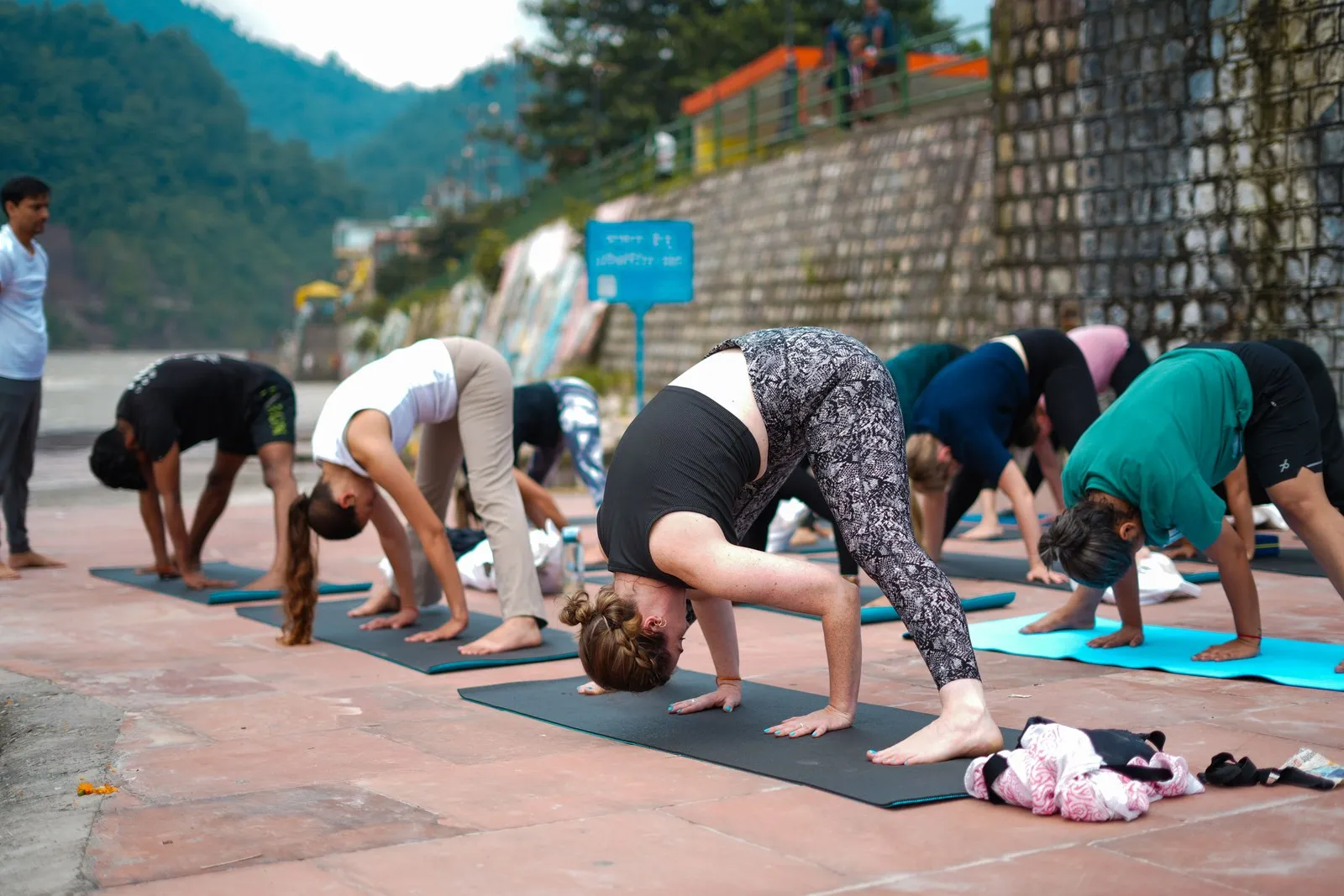 A morning class in downward dog on a terrace by the river, Rishikesh