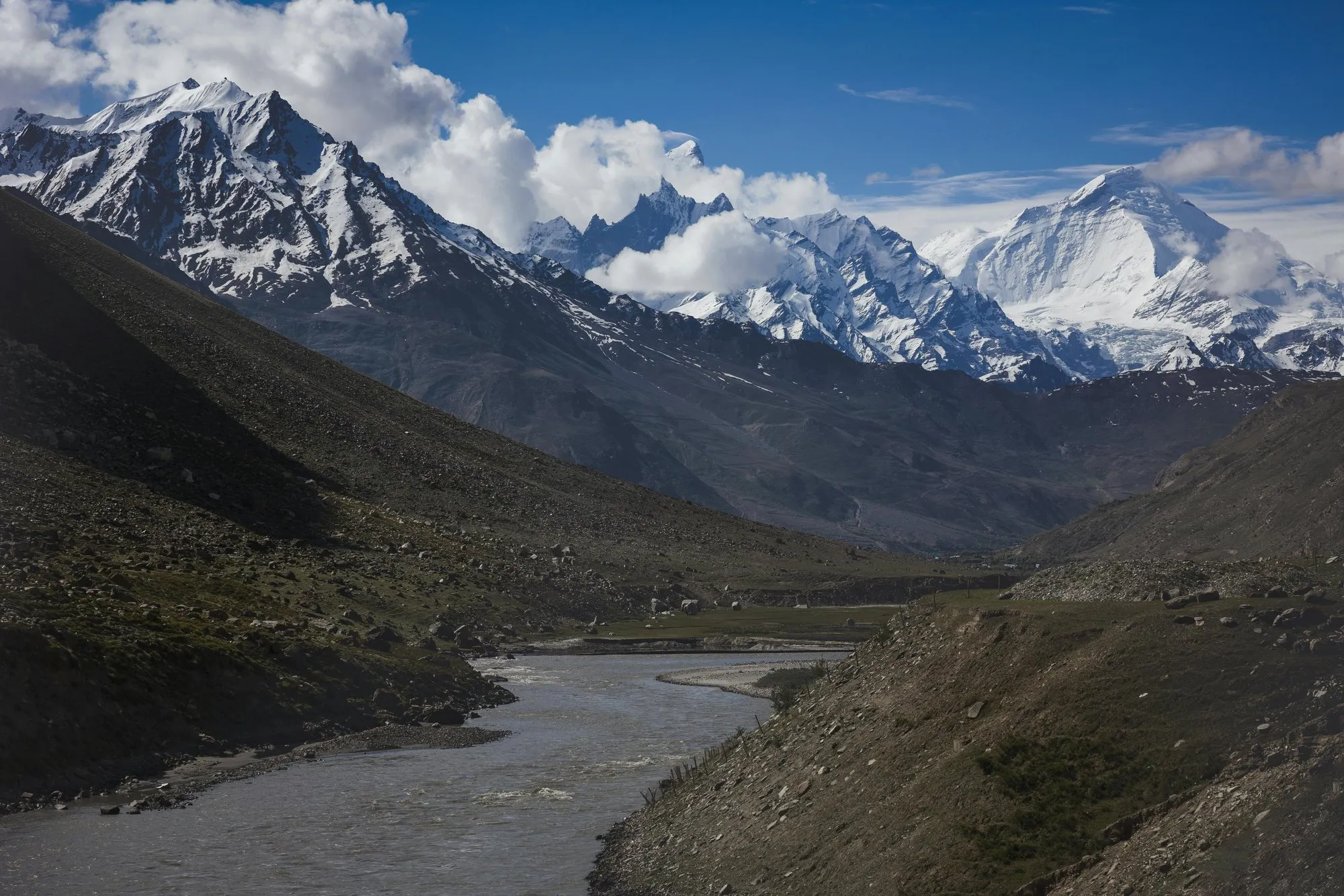 Snow peaks above a river valley