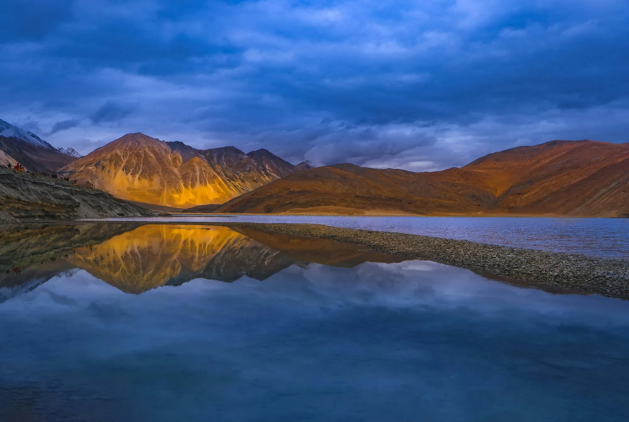 Pangong Lake reflecting the mountains at dusk