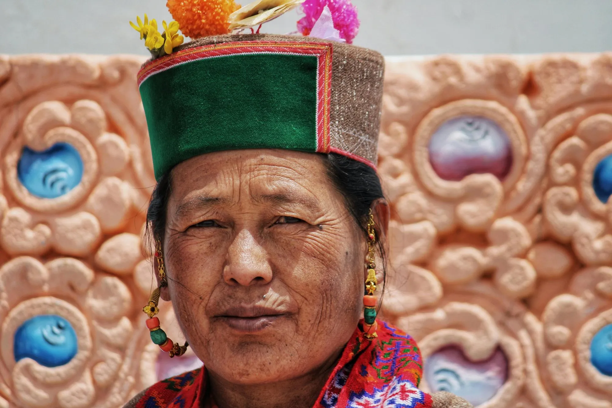 A Ladakhi woman in a tall embroidered hat