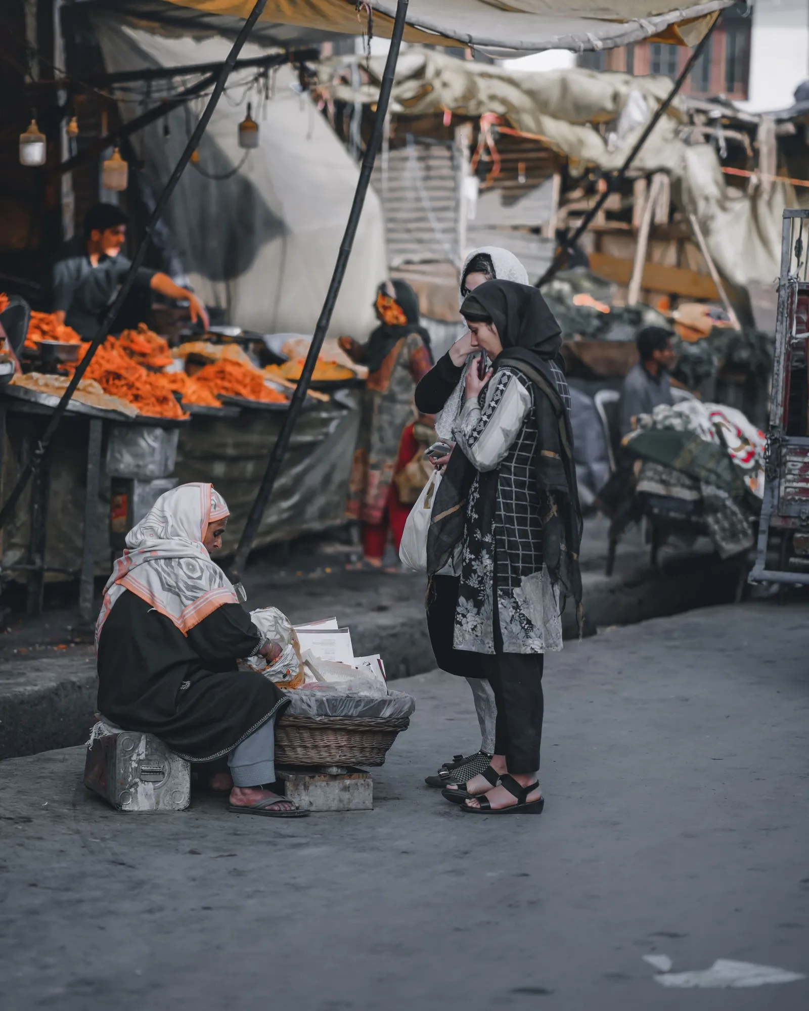 Women buying from a street vendor in a Srinagar market
