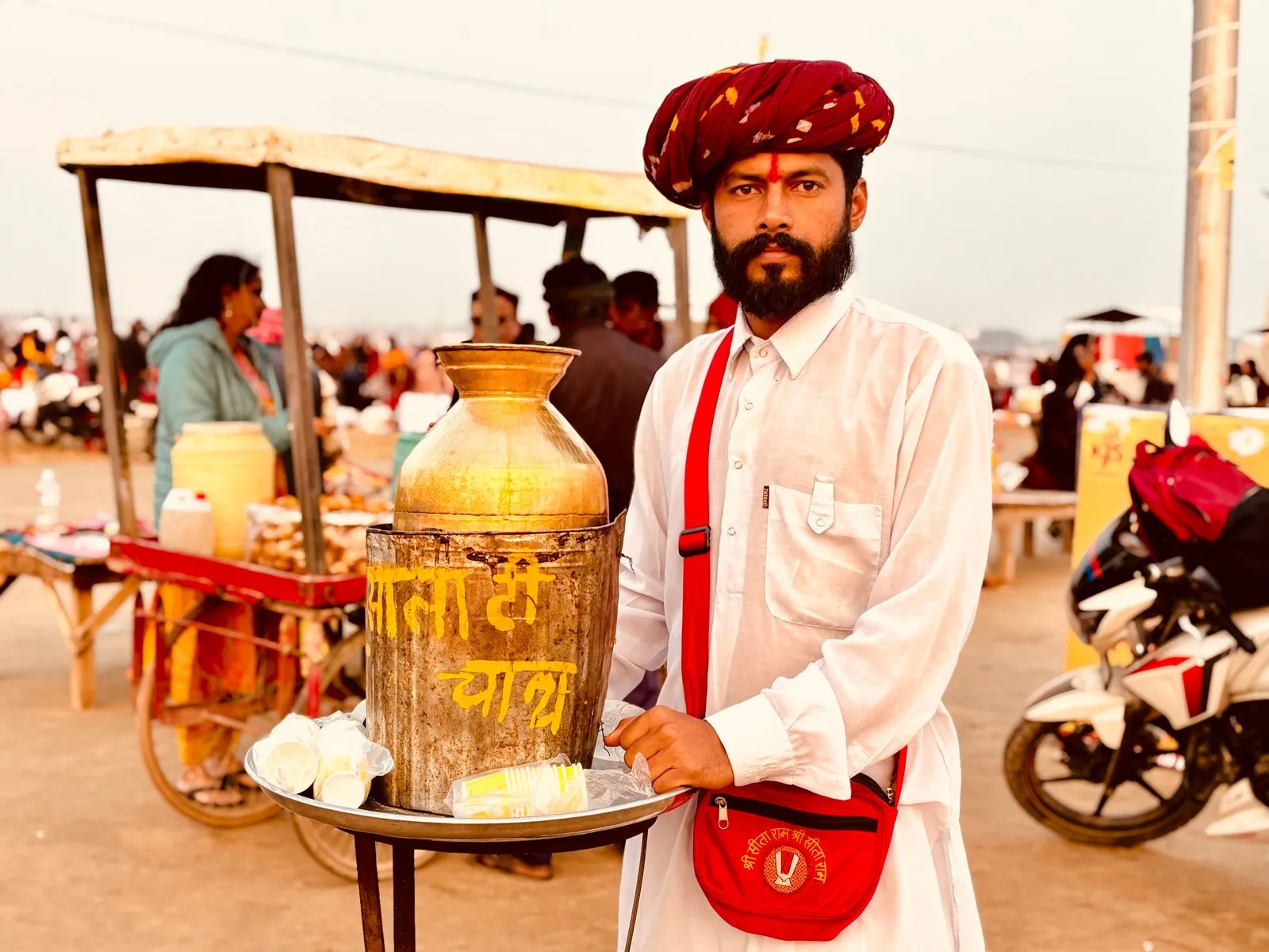 A chai seller in a red turban with his brass urn, Prayagraj