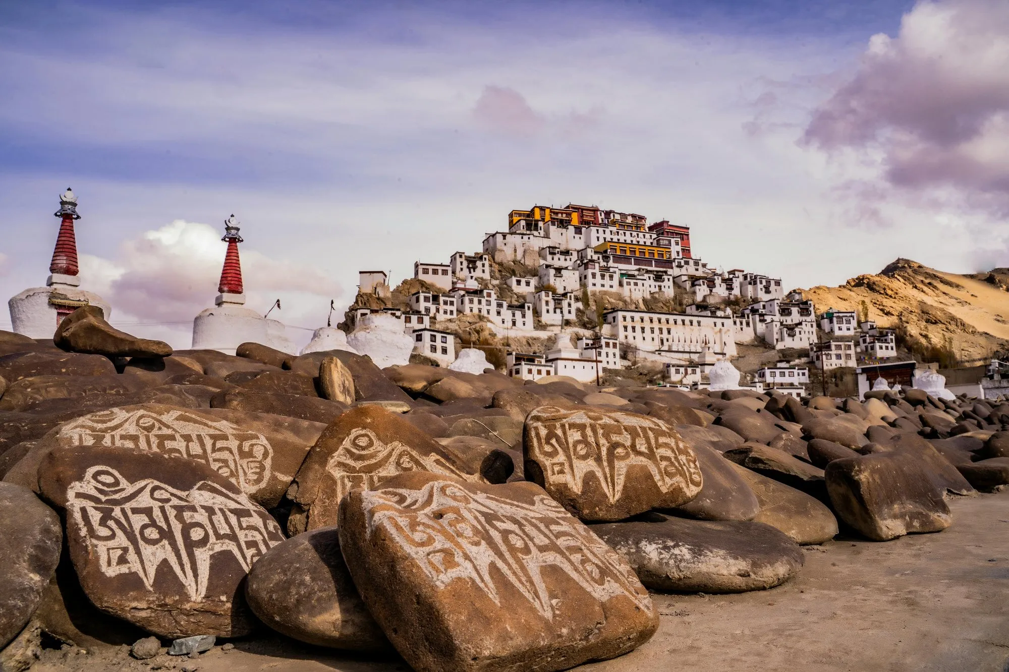 Thiksey Monastery above carved mani stones