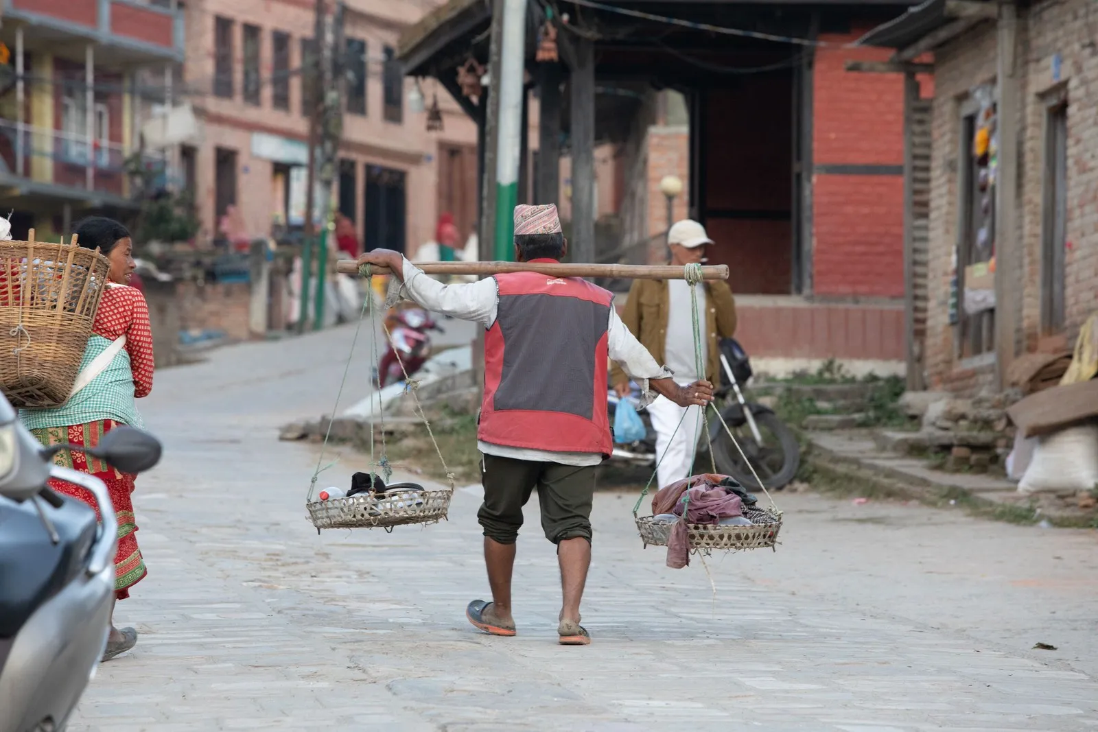 A porter with a carrying pole in a Bhaktapur street