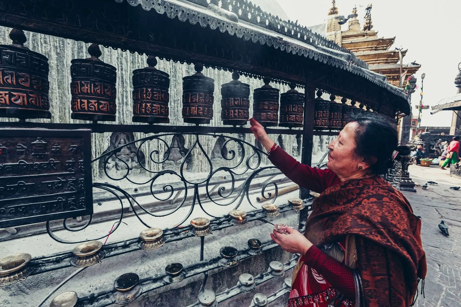 A woman turning the prayer wheels at Swayambhunath