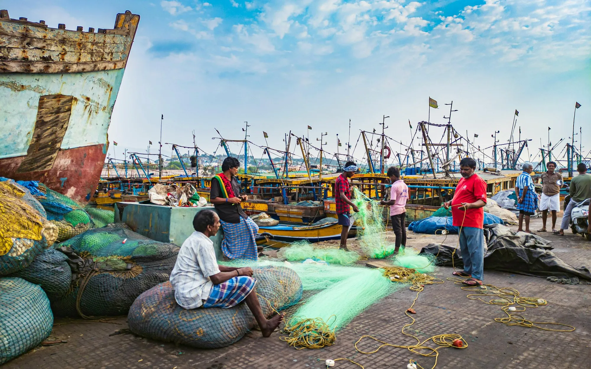 Fishermen mending nets at a harbour