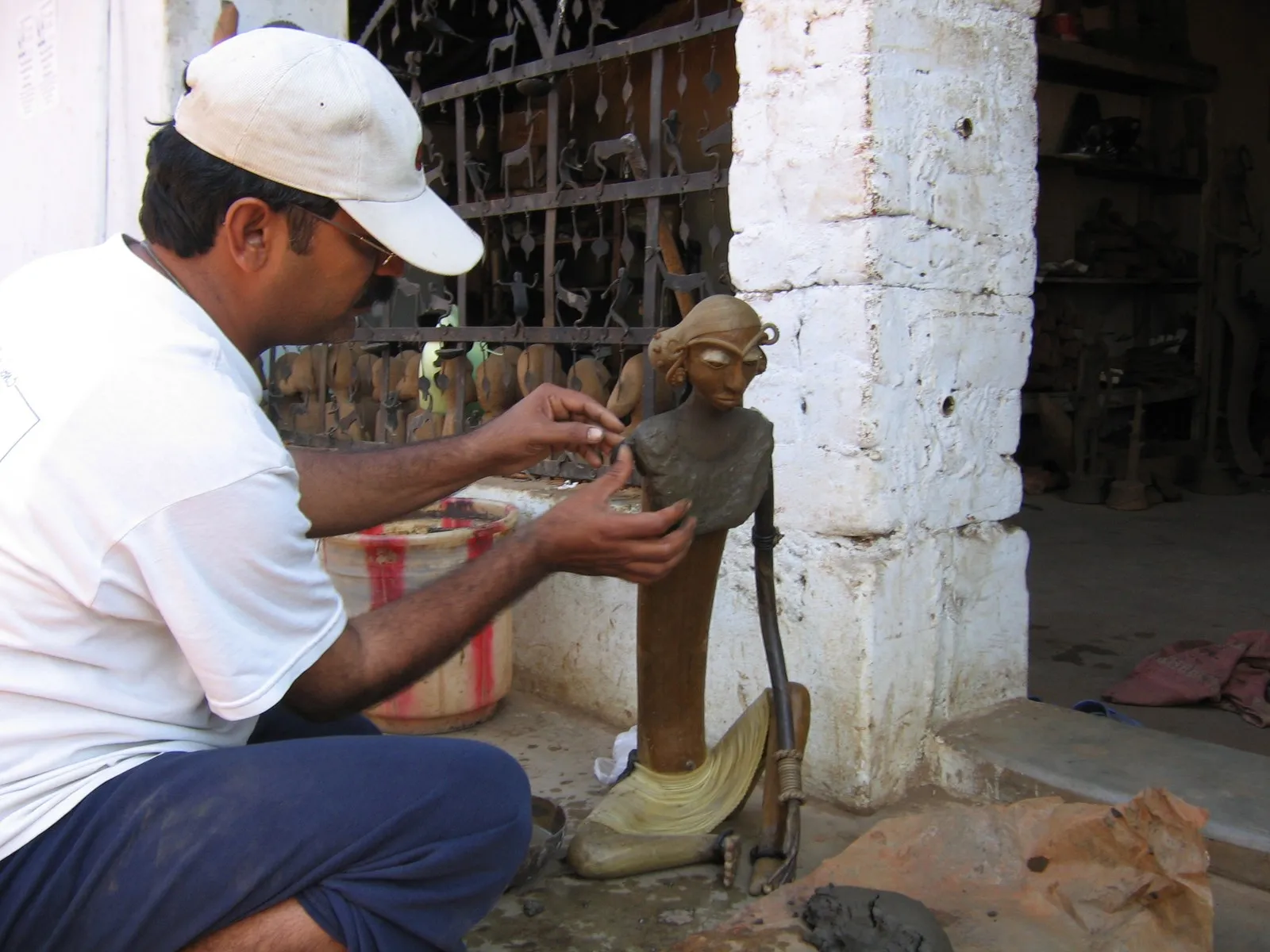 A metalsmith finishing a Dhokra figure in his workshop at Kondagaon, Bastar