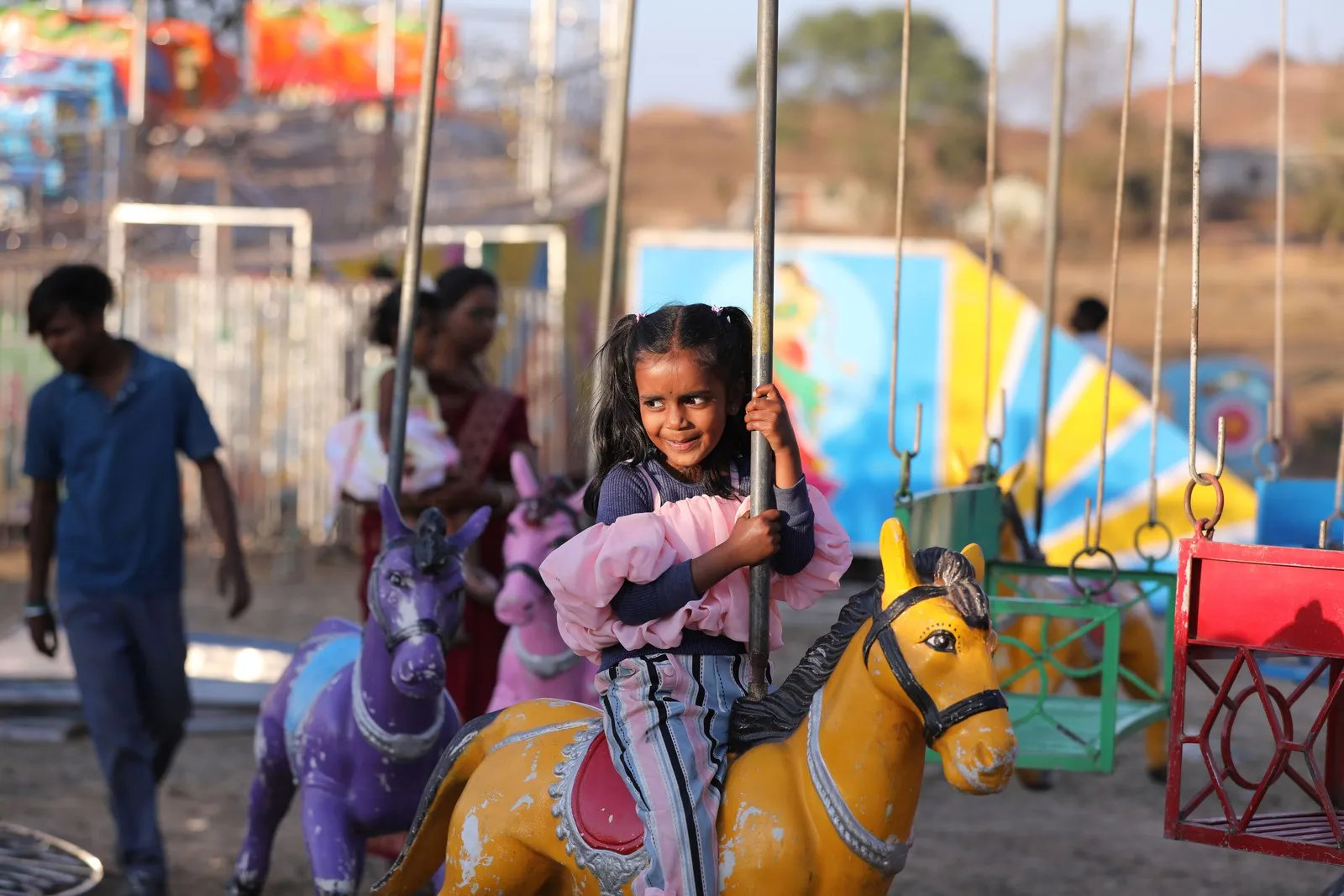 A girl on a carousel at a village fair in Chhattisgarh