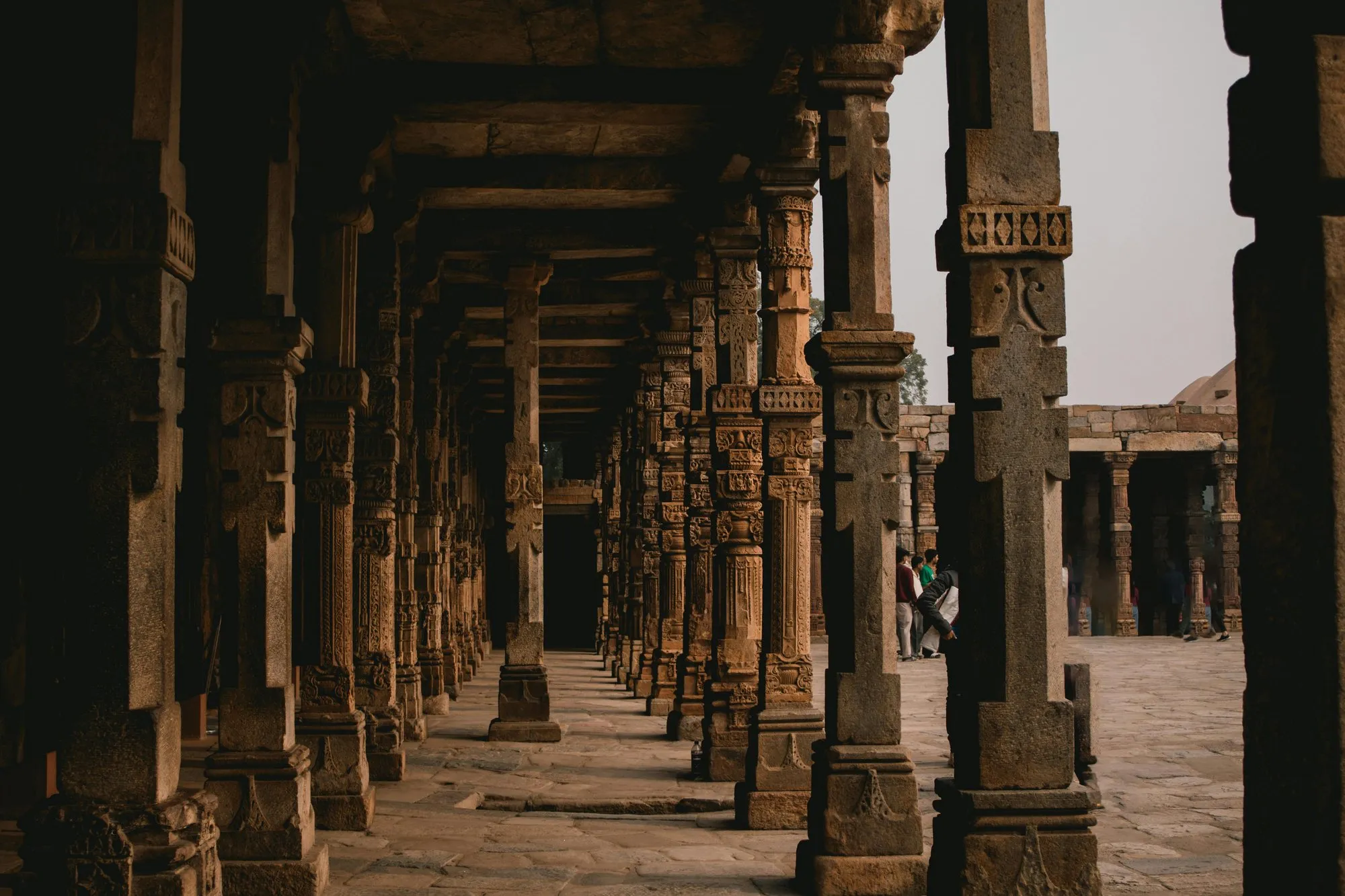 A carved stone colonnade in shadow