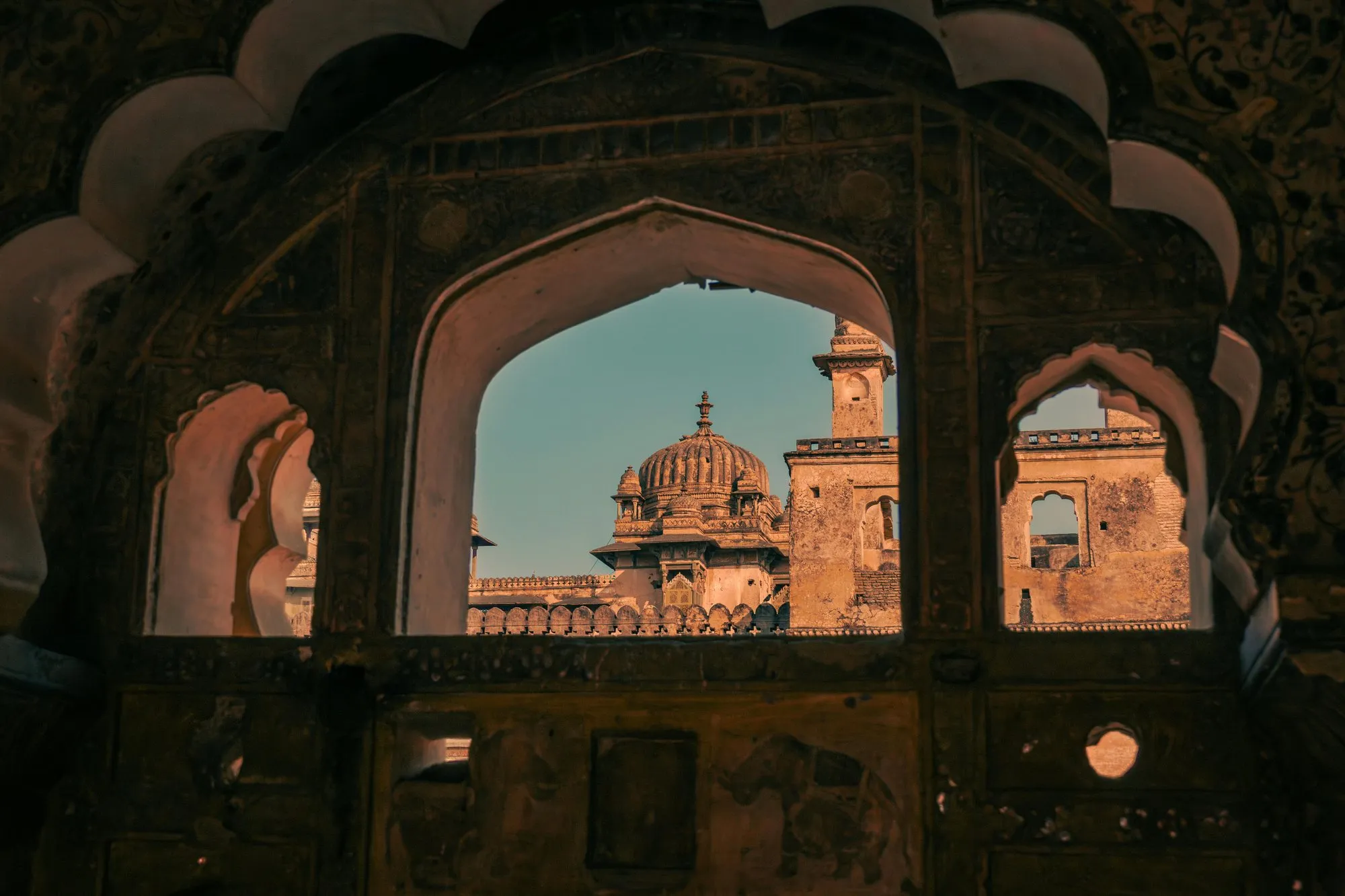 A palace dome seen through a carved arch