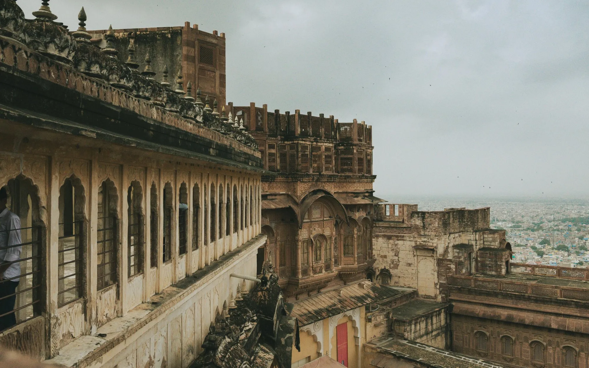 Carved sandstone balconies of a fort above a city