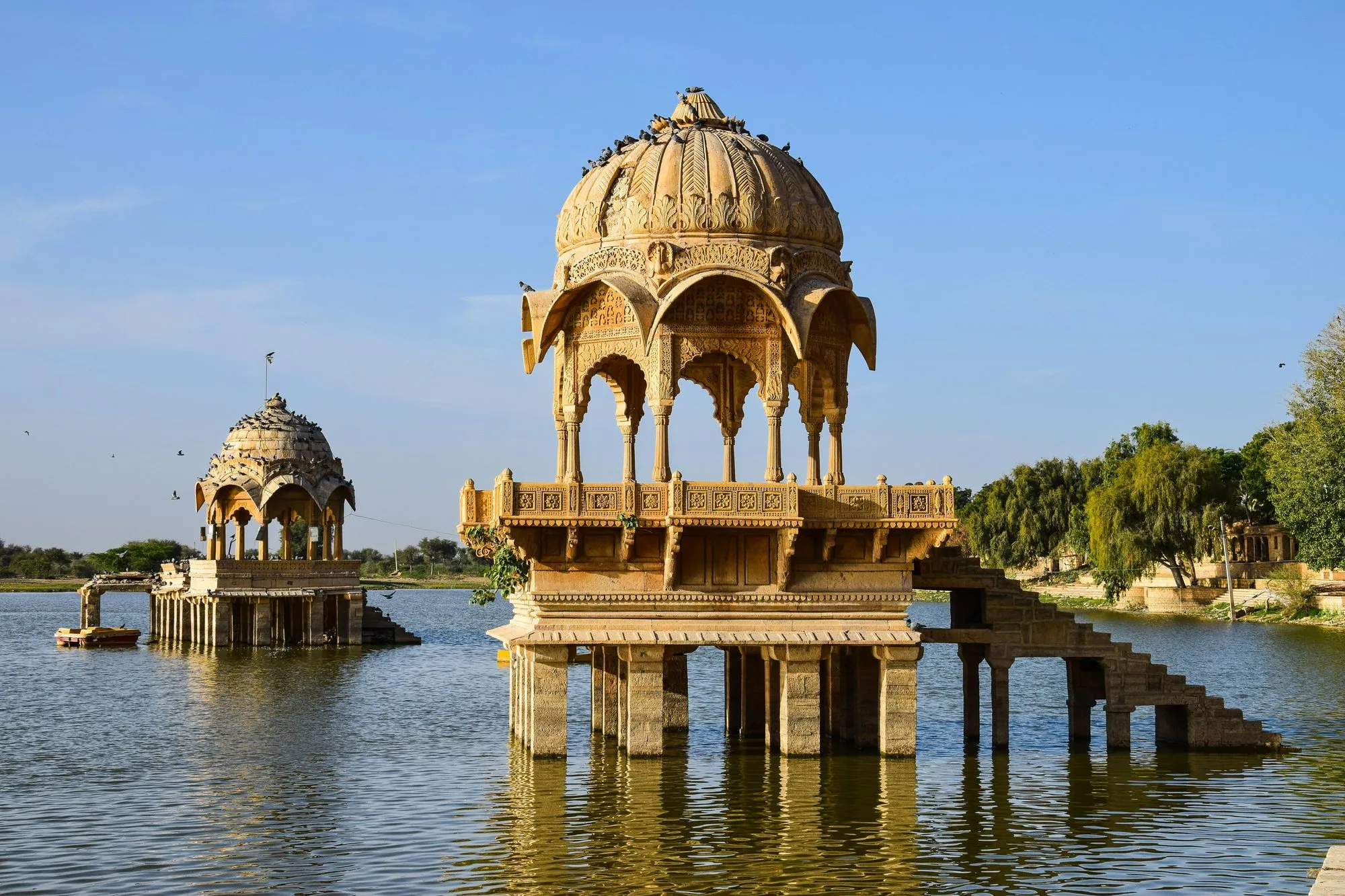 A carved pavilion standing in a desert lake