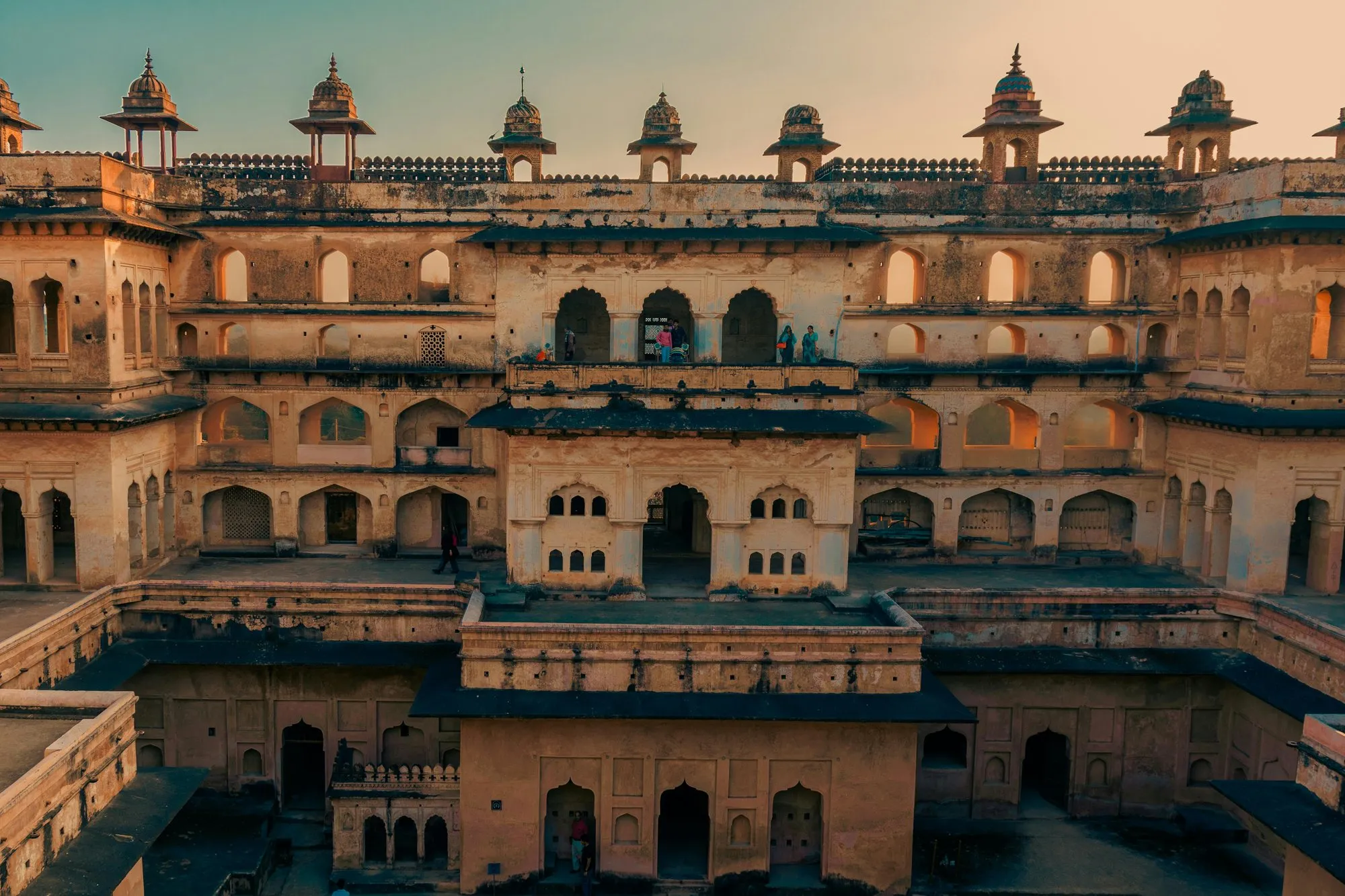 The domes and arcades of an Orchha palace at dusk