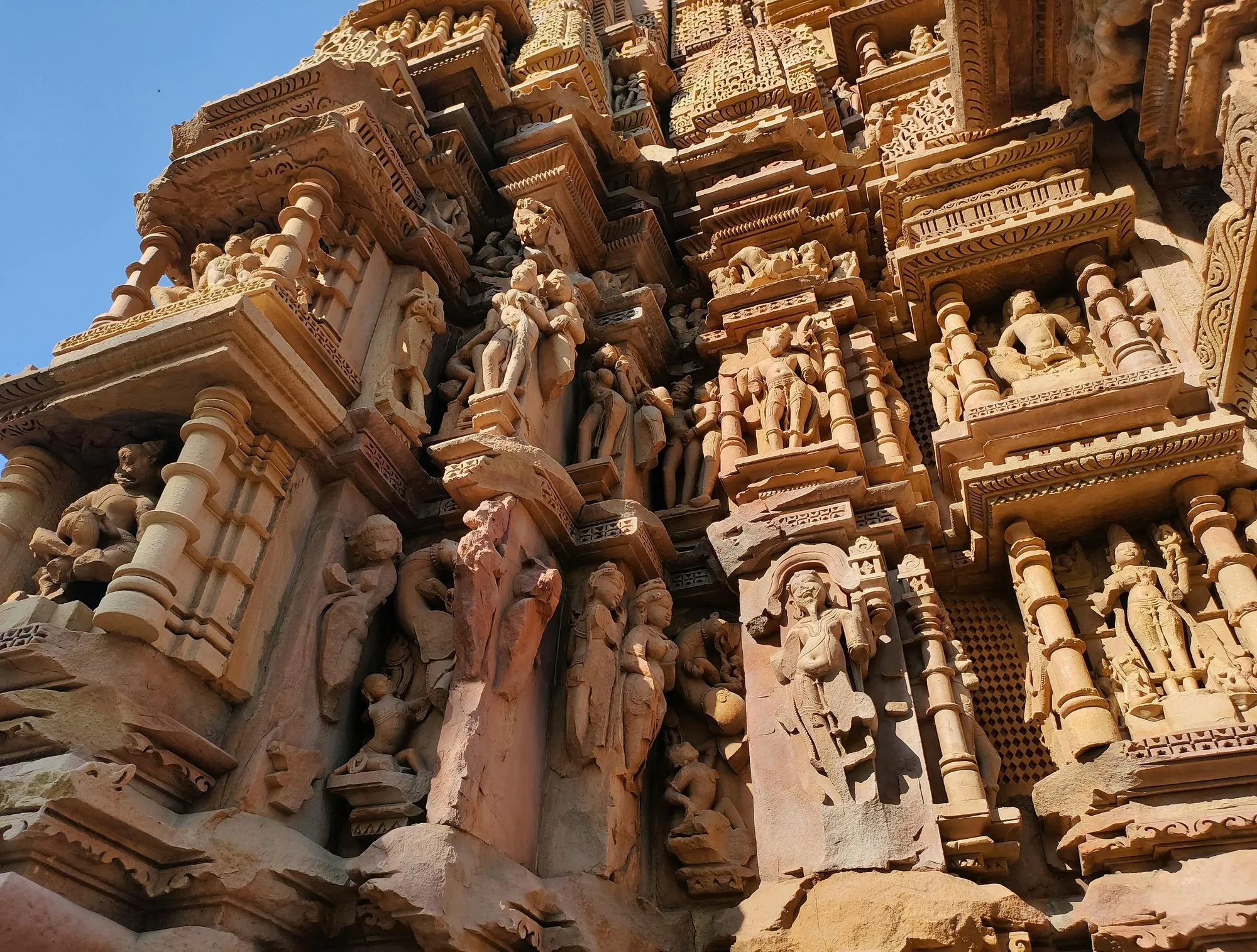 Carved figures crowding a Khajuraho temple wall