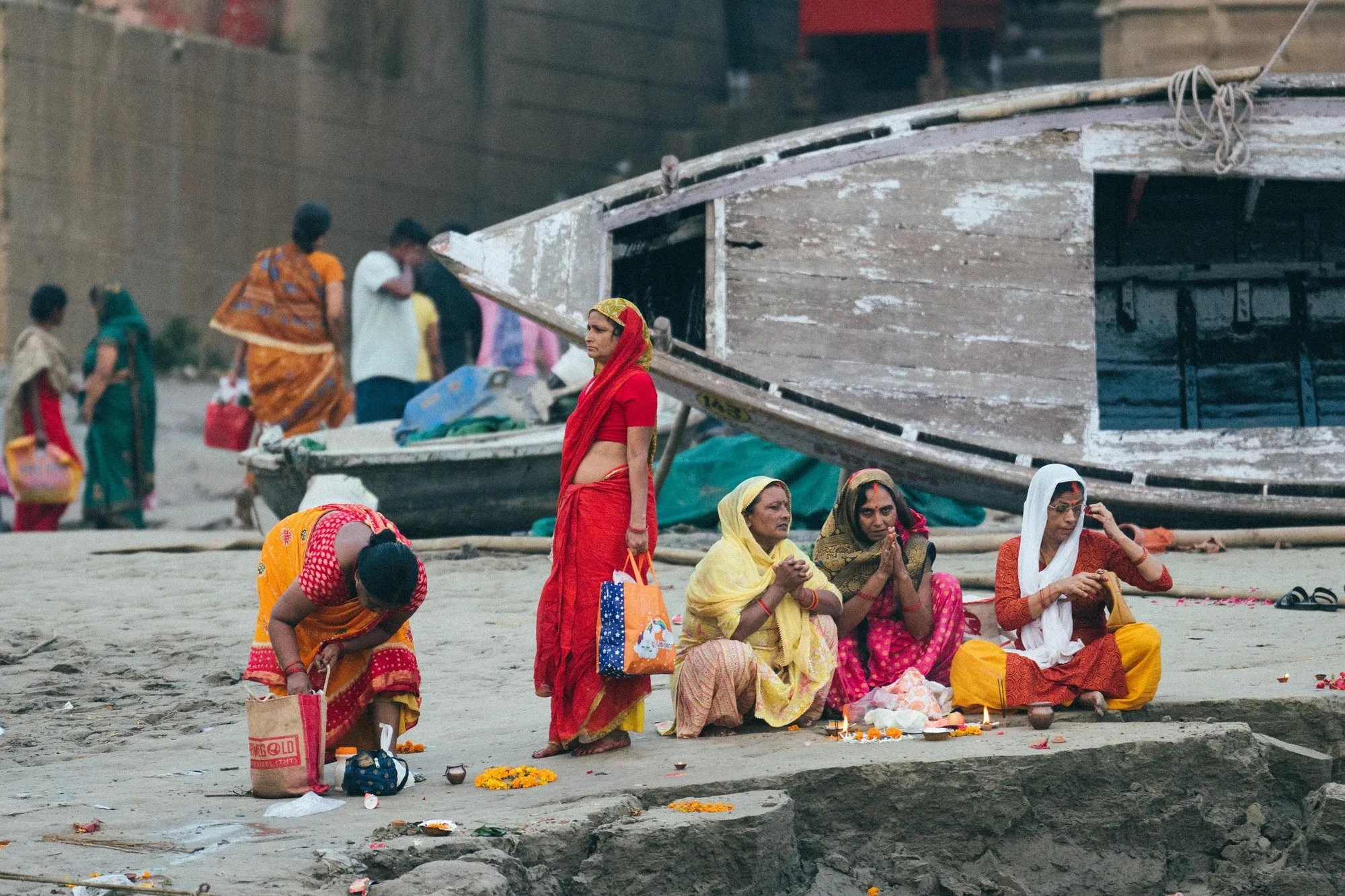Women in bright saris at their morning rituals on the ghat