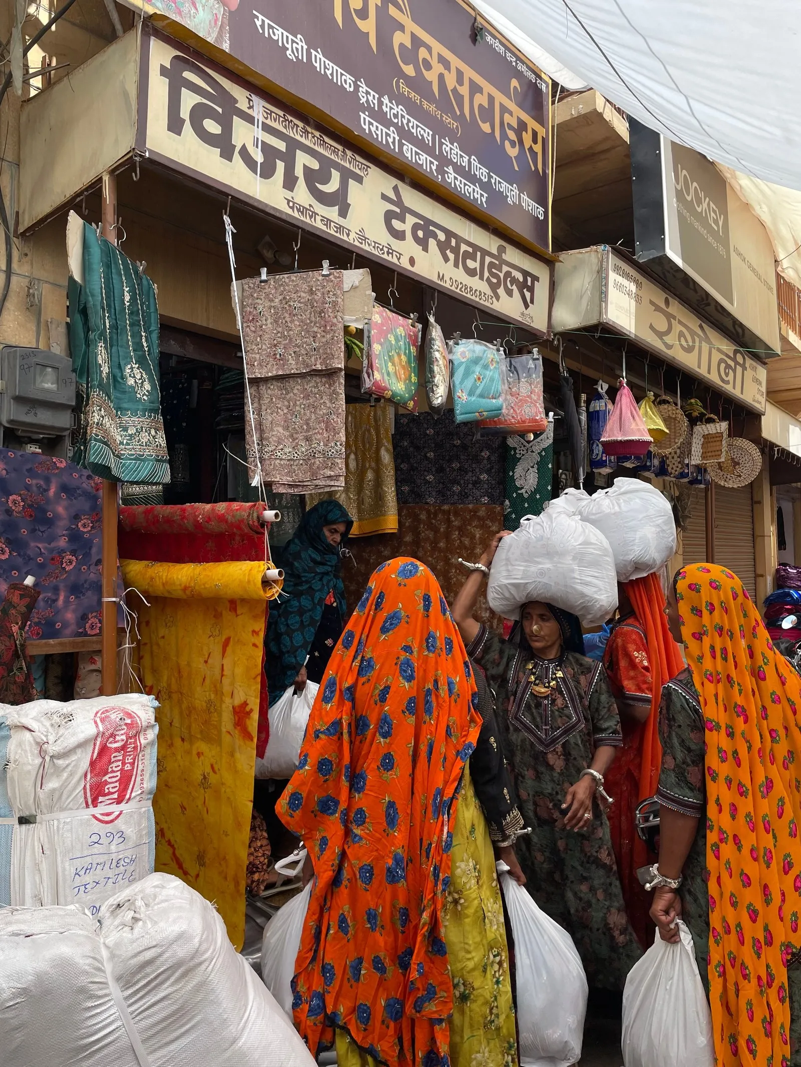 Women with bundles at a textile shop in Jaisalmer’s market