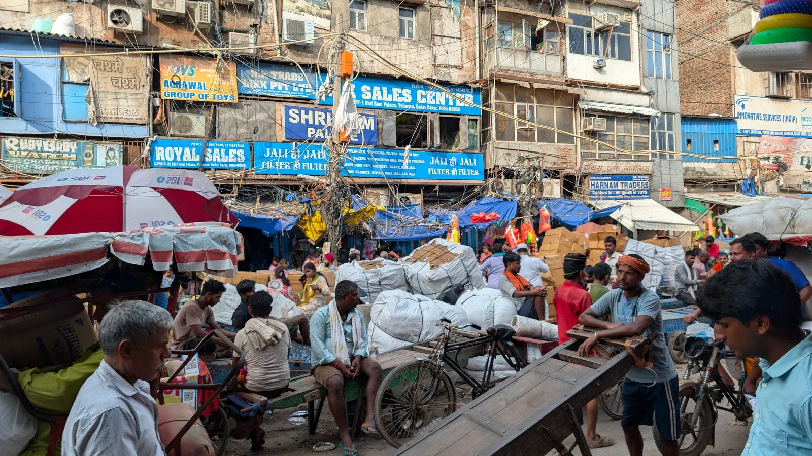 Porters and shoppers in a busy street market in Old Delhi