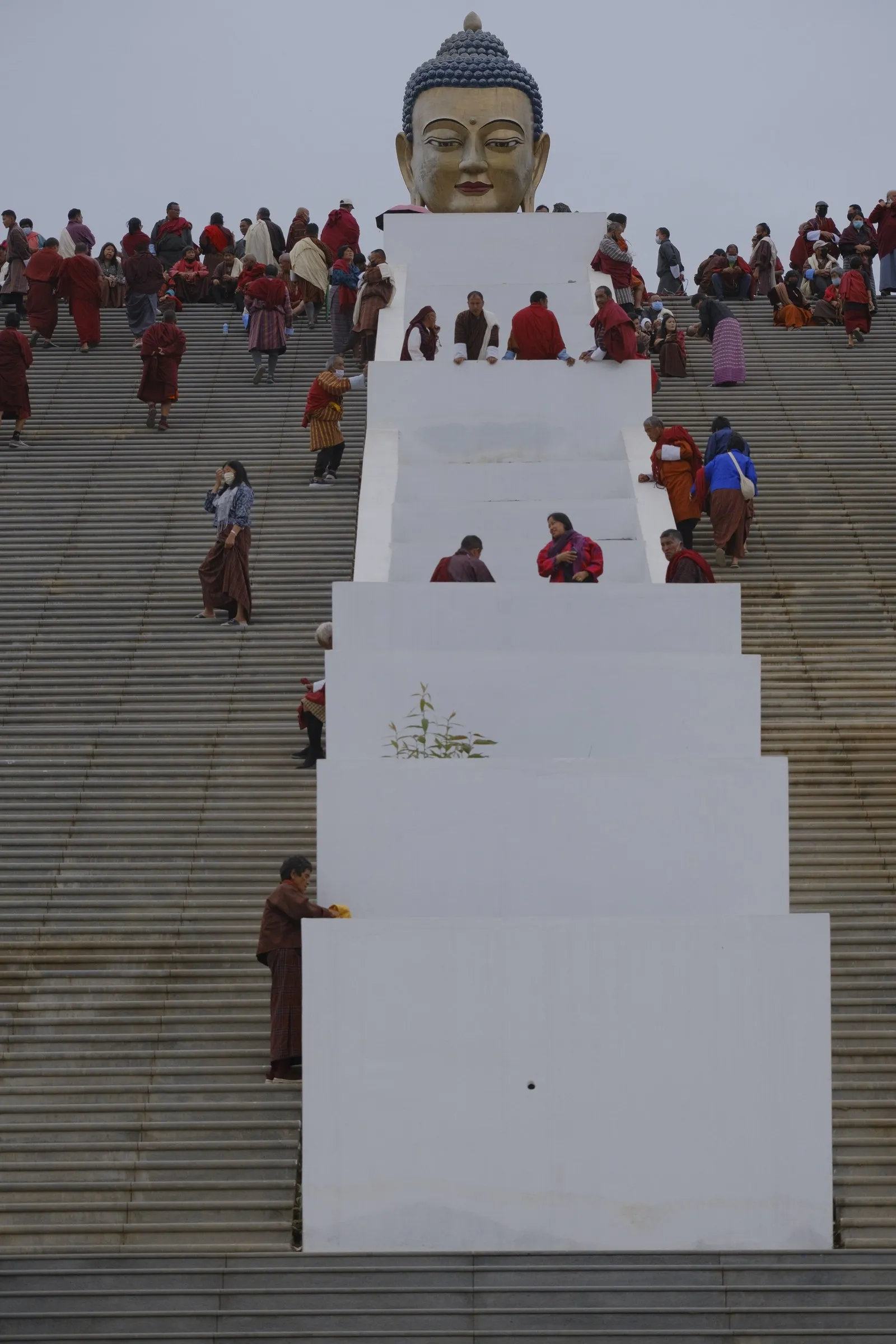 People in national dress climbing the long stairs below the Buddha Dordenma, Thimphu