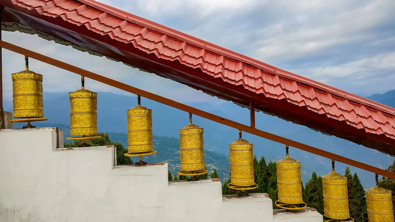 Gilded prayer wheels along the steps of Enchey Monastery, Gangtok