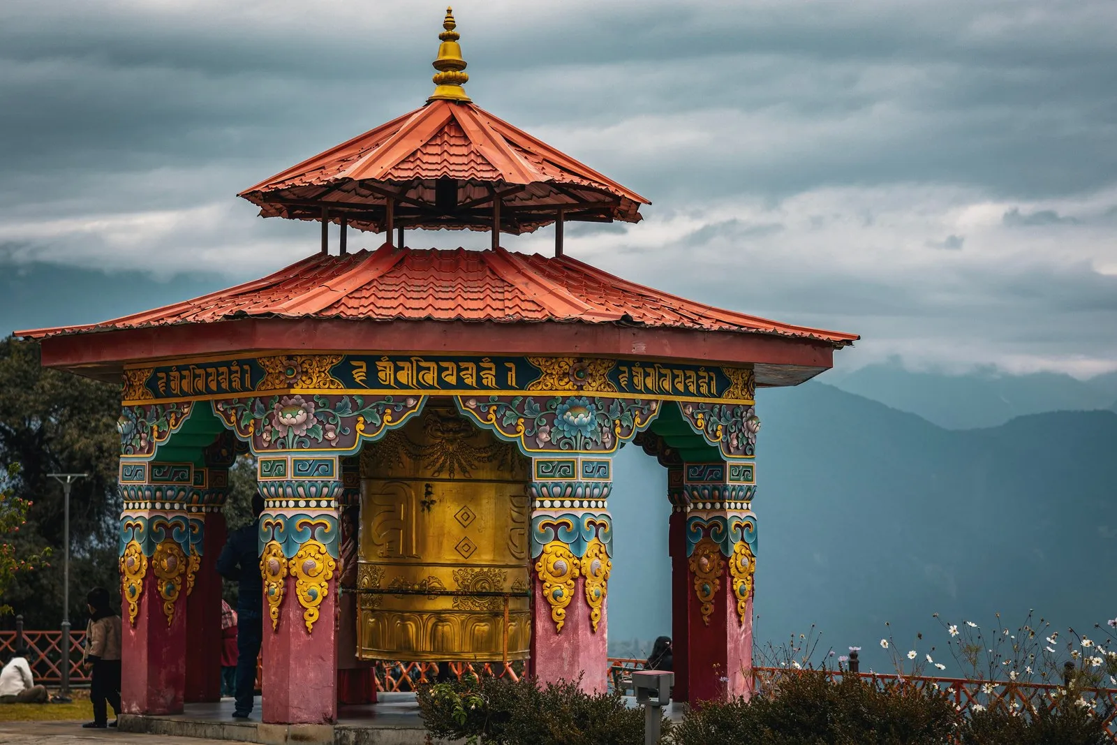 A painted pavilion around a great prayer wheel above the hills at Pelling, Sikkim