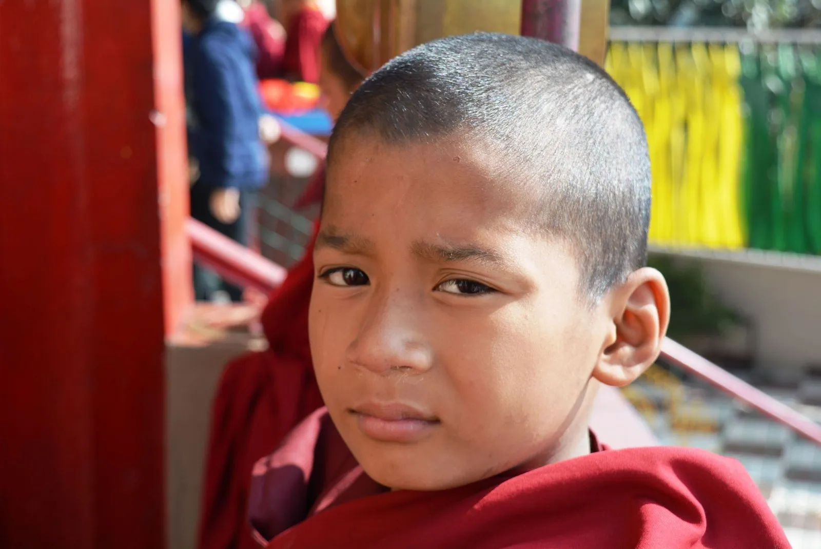A young monk in maroon robes at a monastery in Gangtok