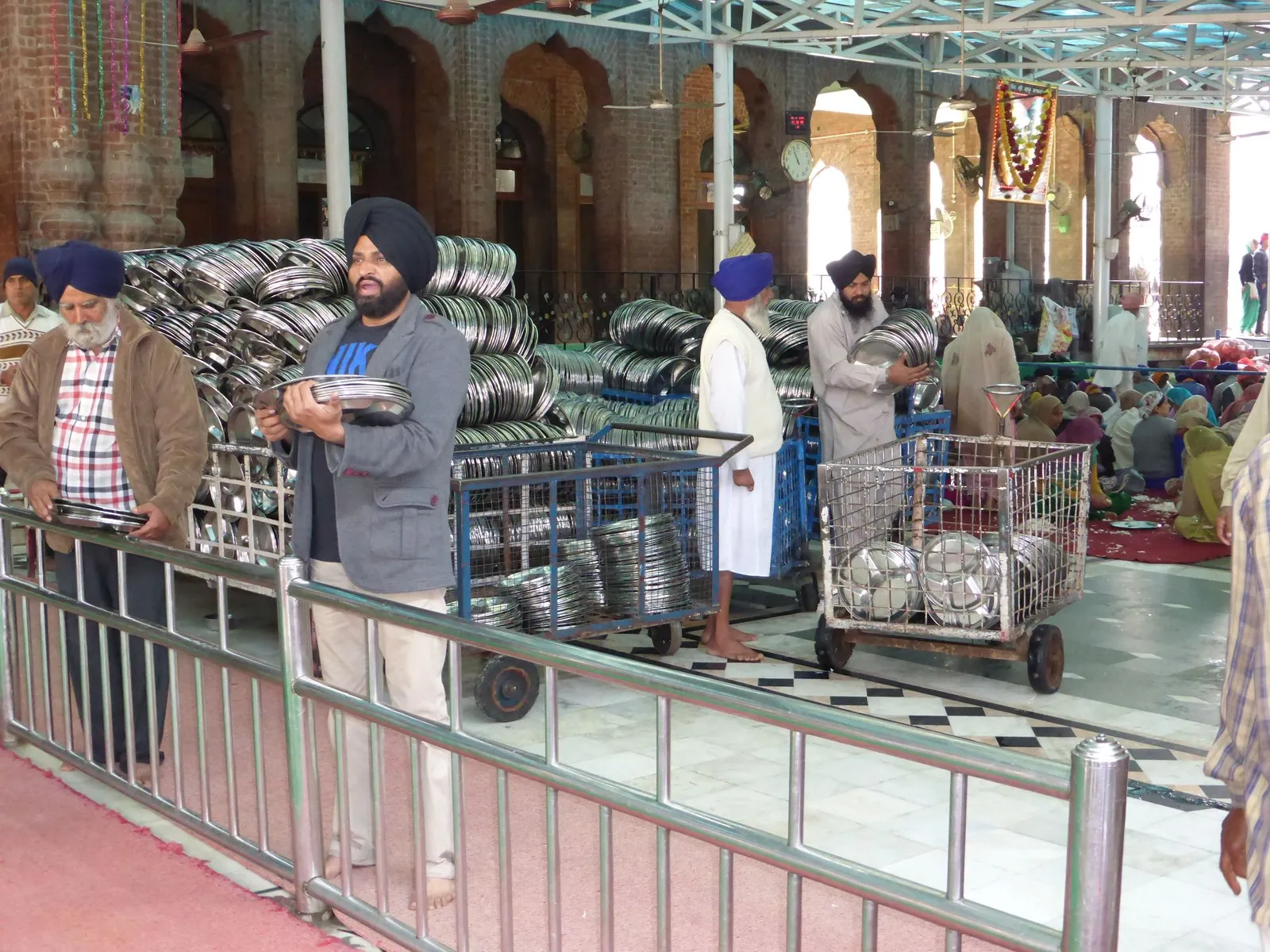 Sikh volunteers with steel plates for the langar at the Golden Temple, Amritsar
