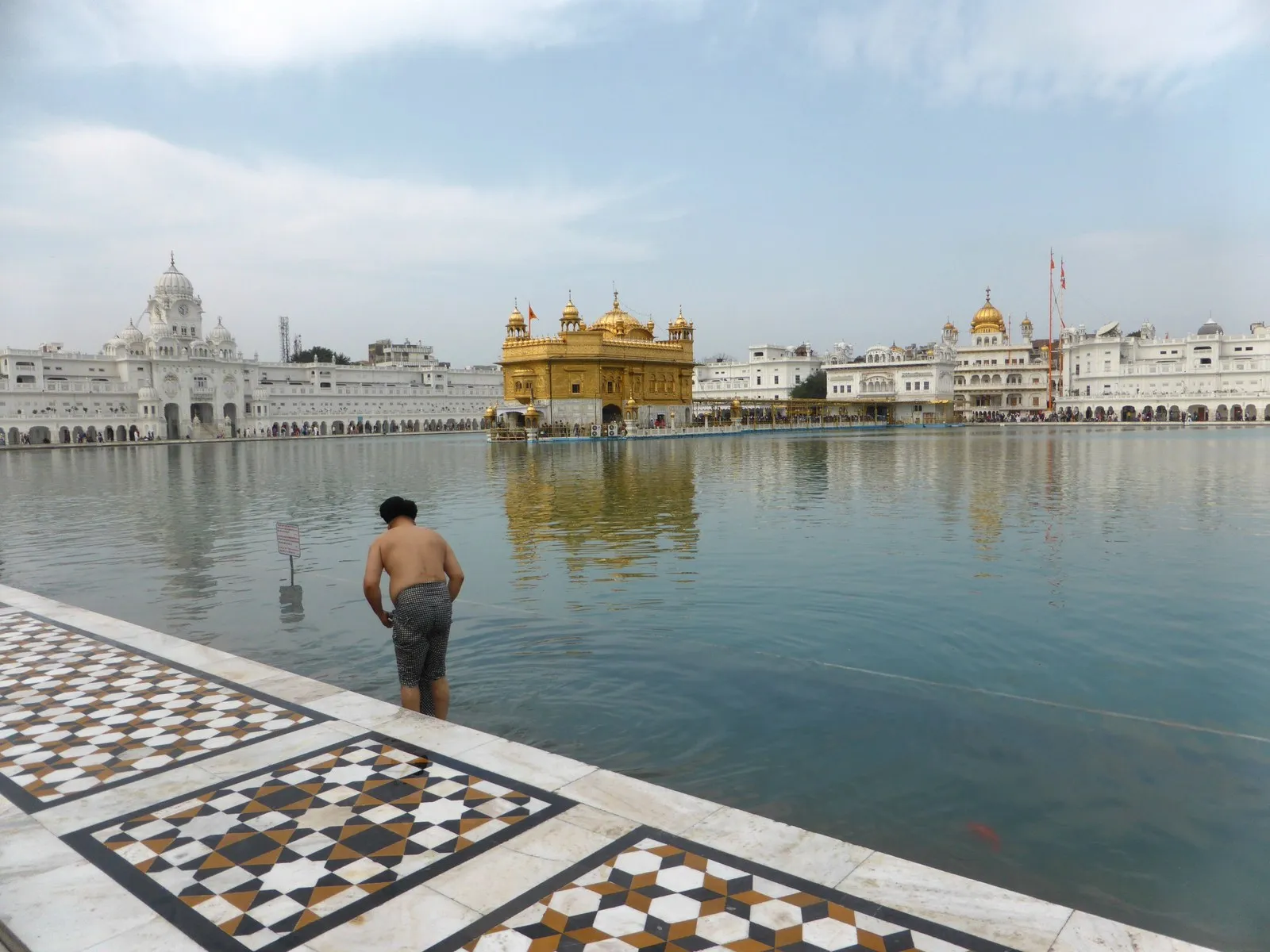 A pilgrim bathing in the sacred pool of the Golden Temple, Amritsar