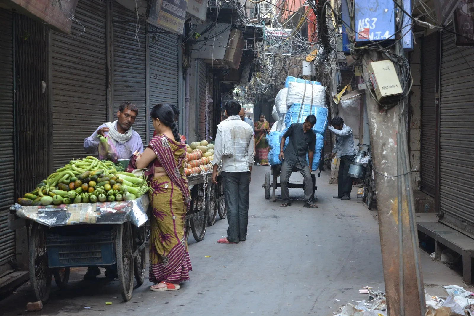 Vendors and porters in a market lane in Old Delhi