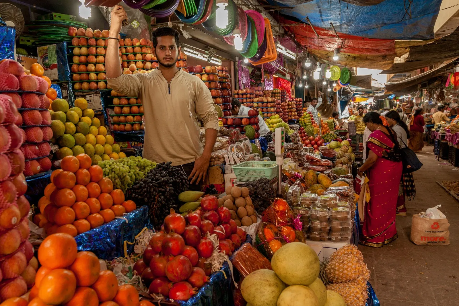 A fruit seller at his stall in a Mysore market