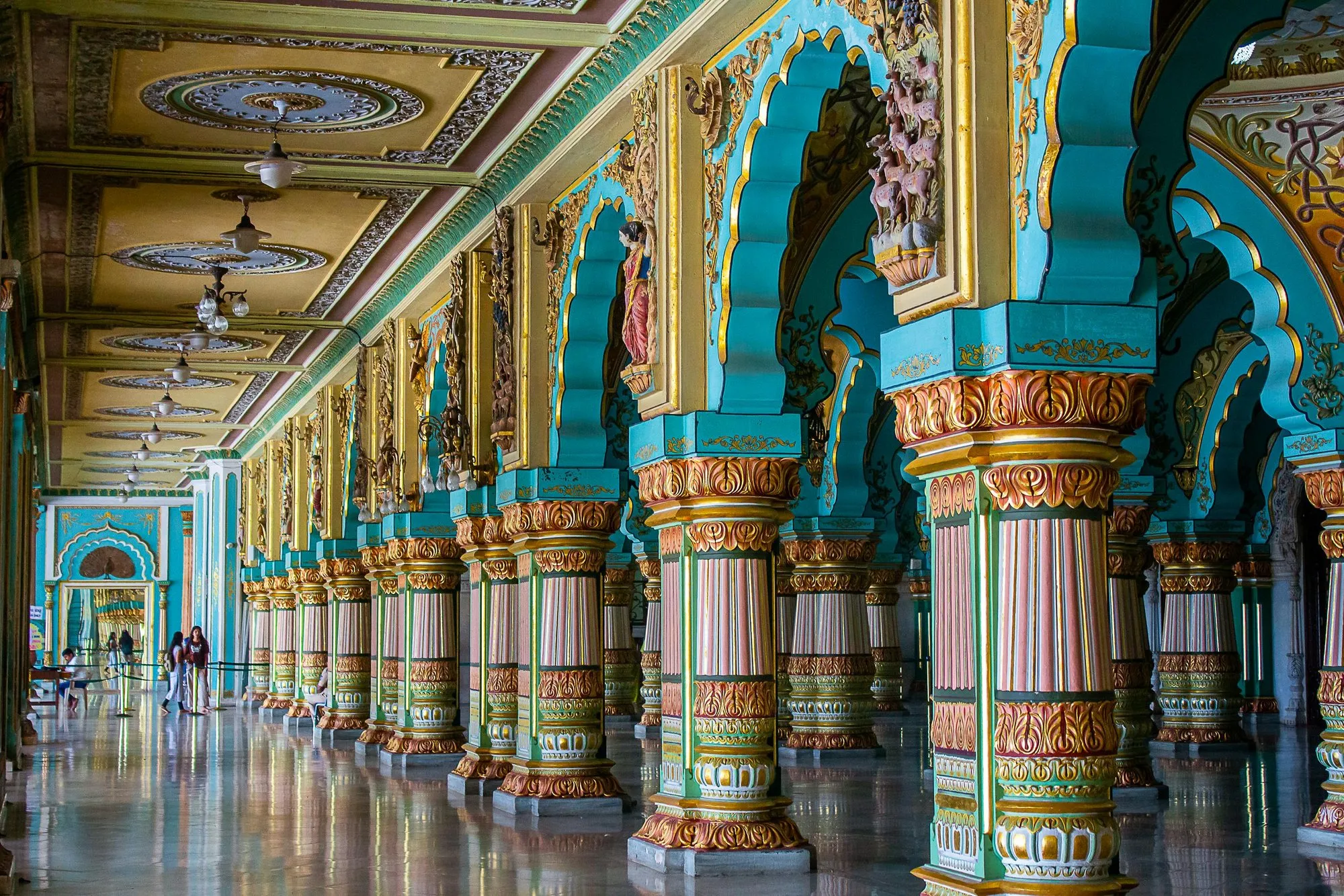 A long hall of painted pillars and arches