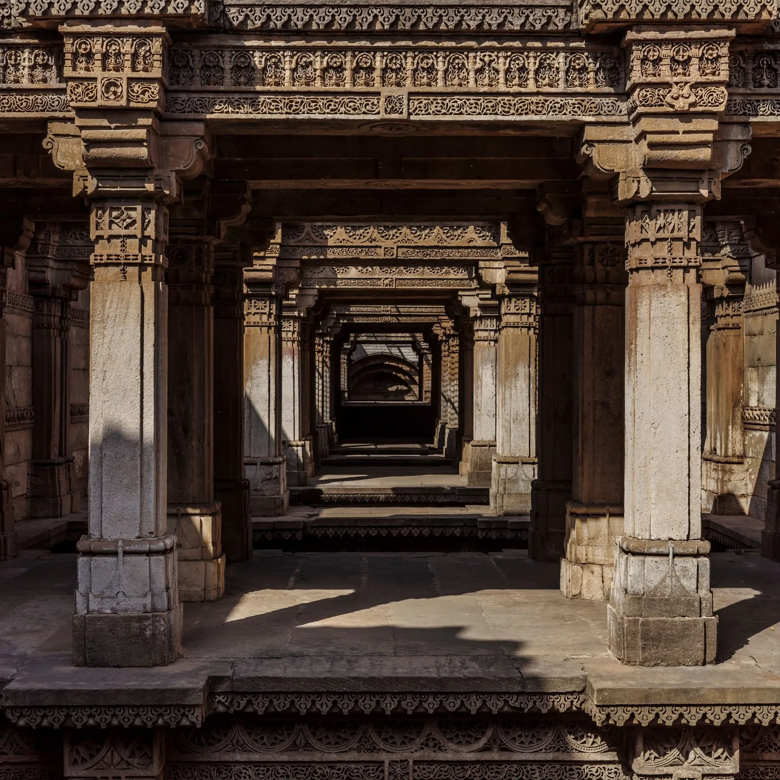 Carved pillars and galleries descending into the Adalaj stepwell