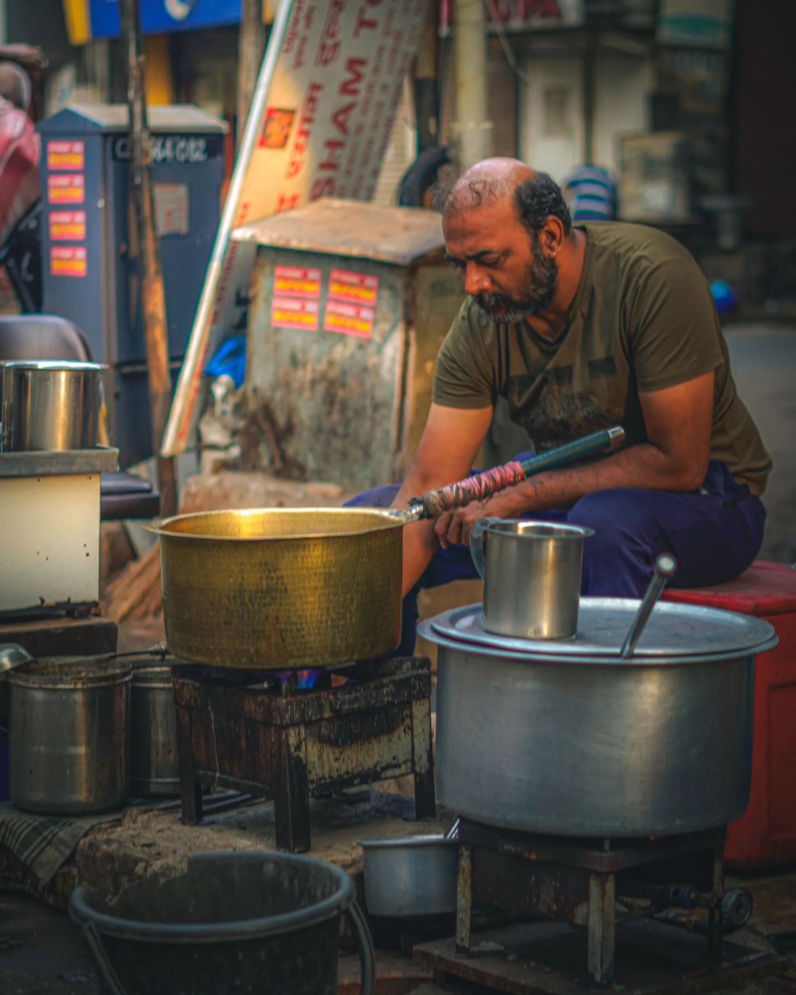 A street cook at his pots in an Ahmedabad market