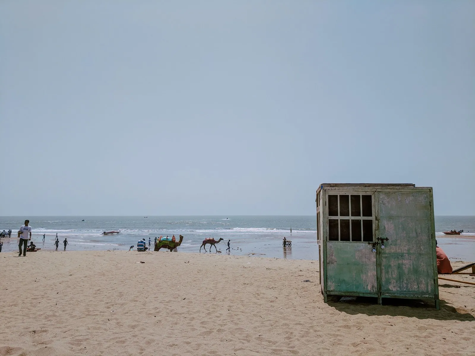 Camels and walkers on the beach at Mandvi