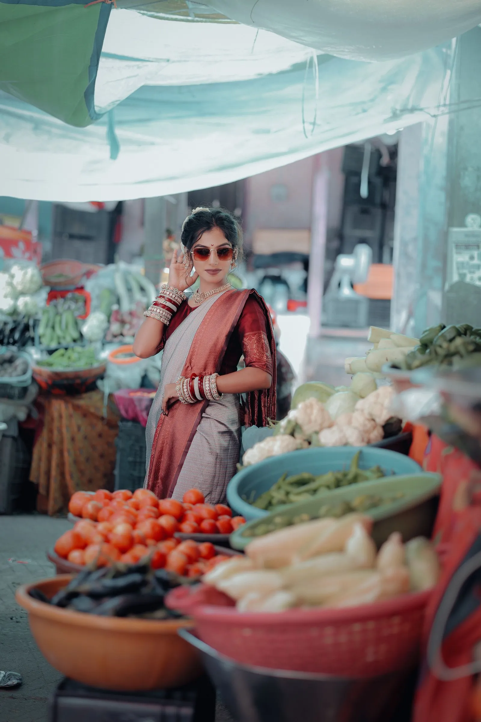A woman choosing vegetables at the market in Mandvi
