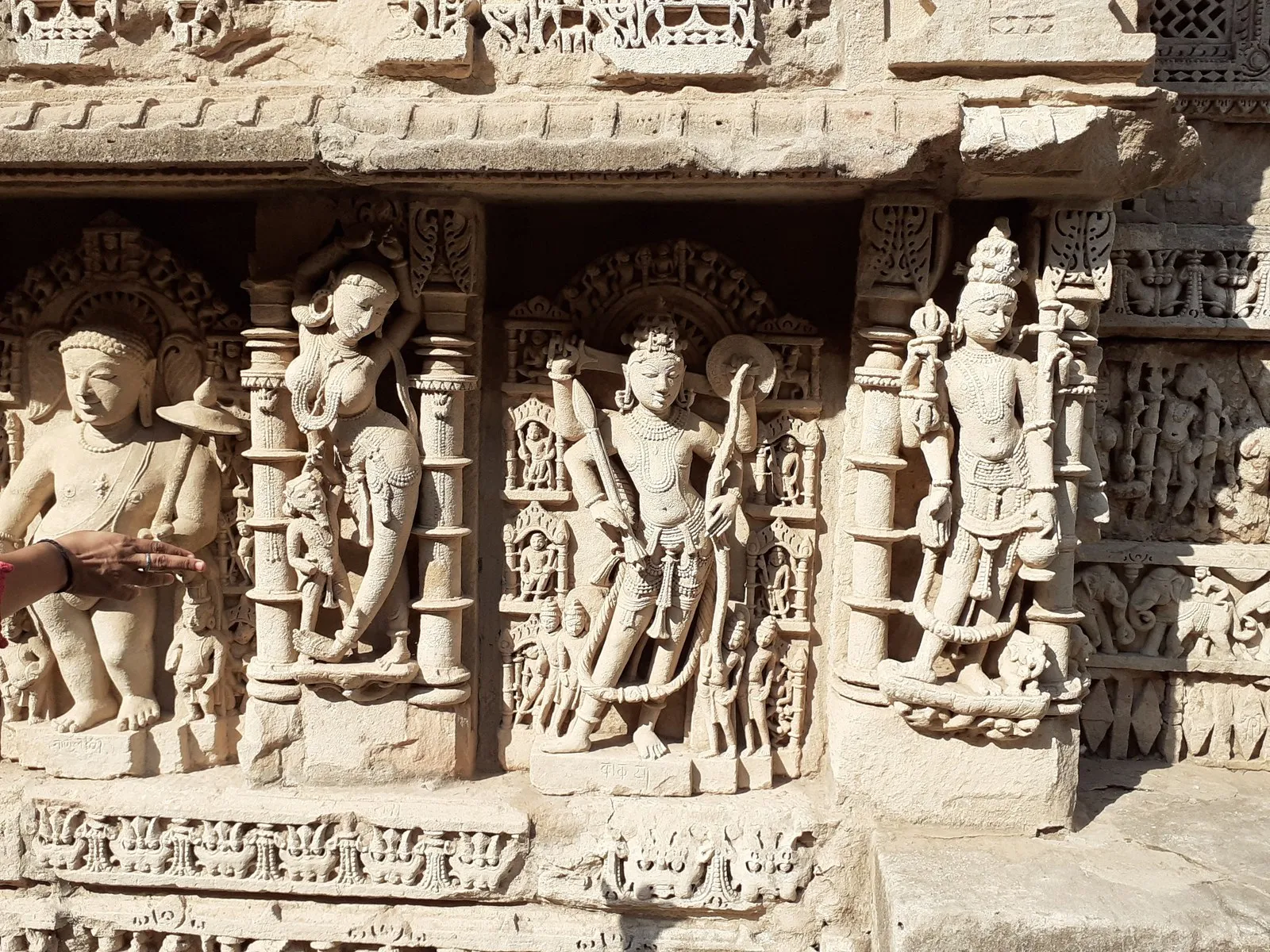 Carved figures of gods and apsaras on a wall of the Rani ki Vav, Patan