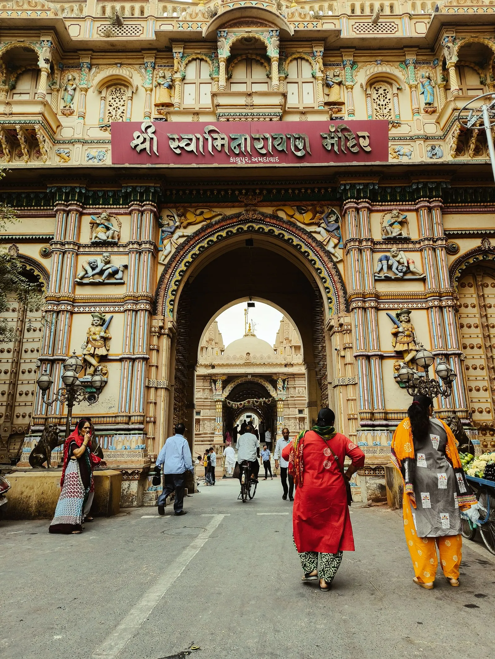 Worshippers at the carved gateway of the Swaminarayan temple in Ahmedabad’s old city