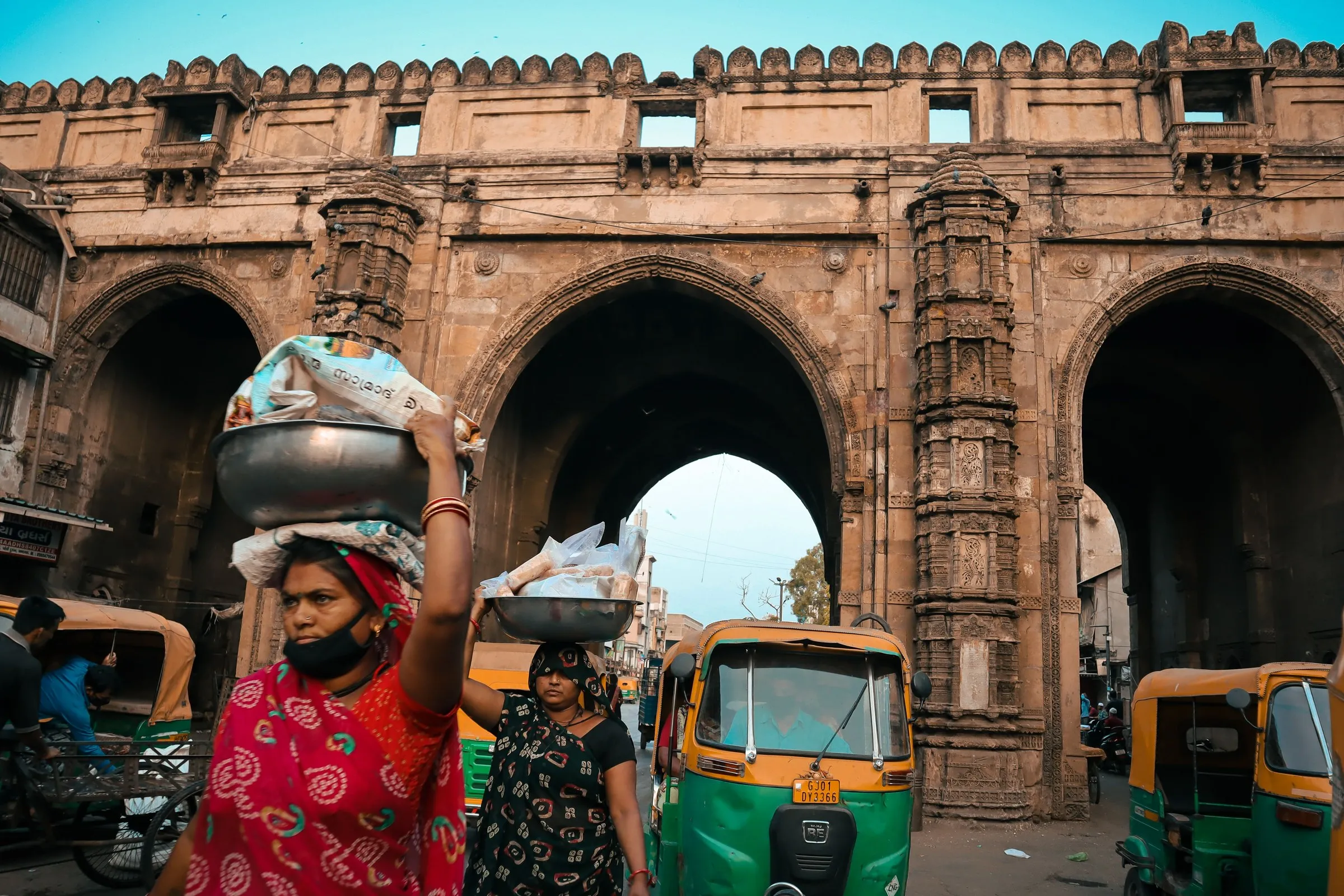 Women carrying loads on their heads under the arches of the Teen Darwaza, Ahmedabad