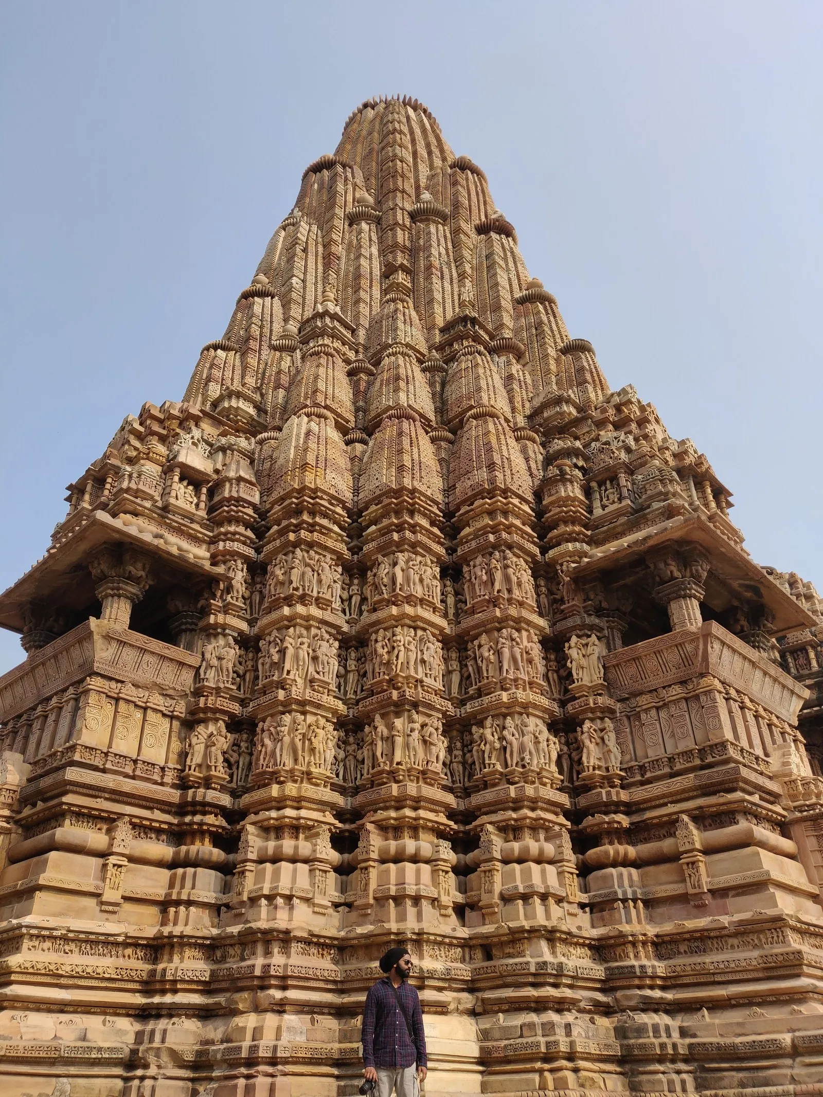 A visitor at the foot of the Kandariya Mahadeva temple, Khajuraho