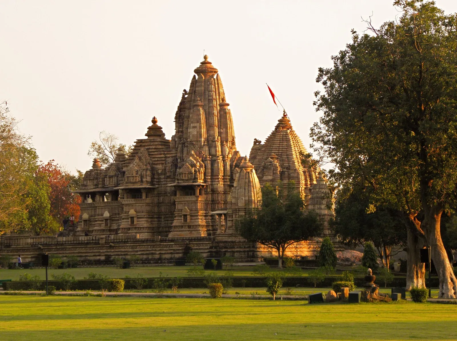 The temples of Khajuraho in the evening light beyond the lawns, Madhya Pradesh