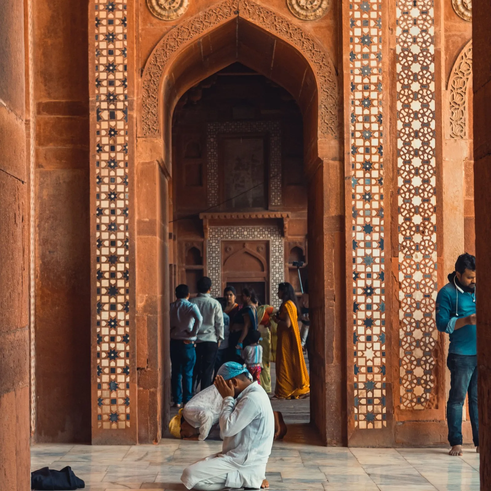 A man at prayer in the courtyard of the Jama Masjid at Fatehpur Sikri