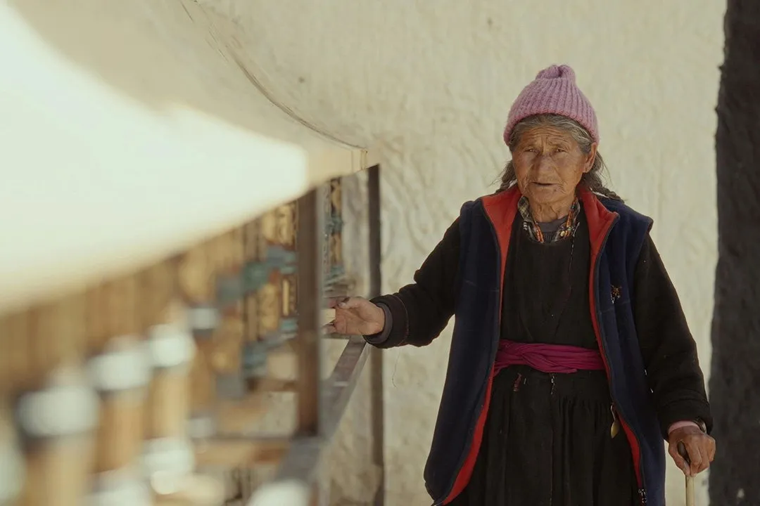 A Ladakhi woman turning the prayer wheels