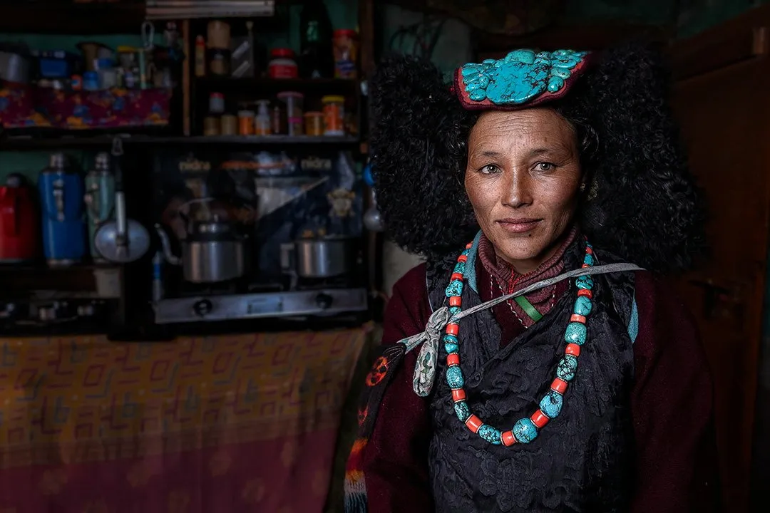 A Ladakhi woman in a turquoise perak in her shop