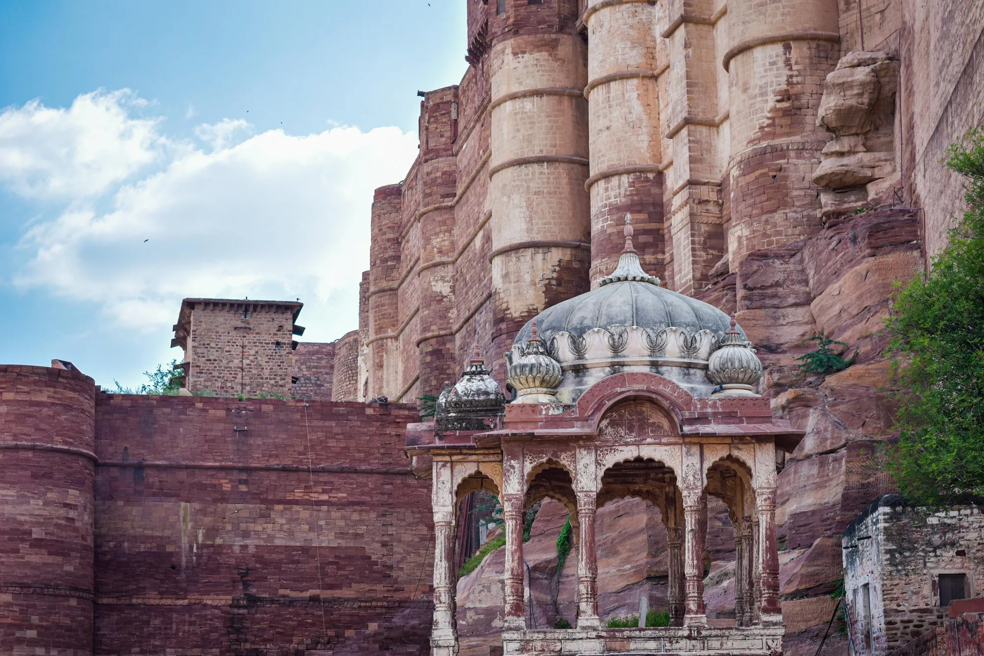 The walls of Mehrangarh above a small white pavilion