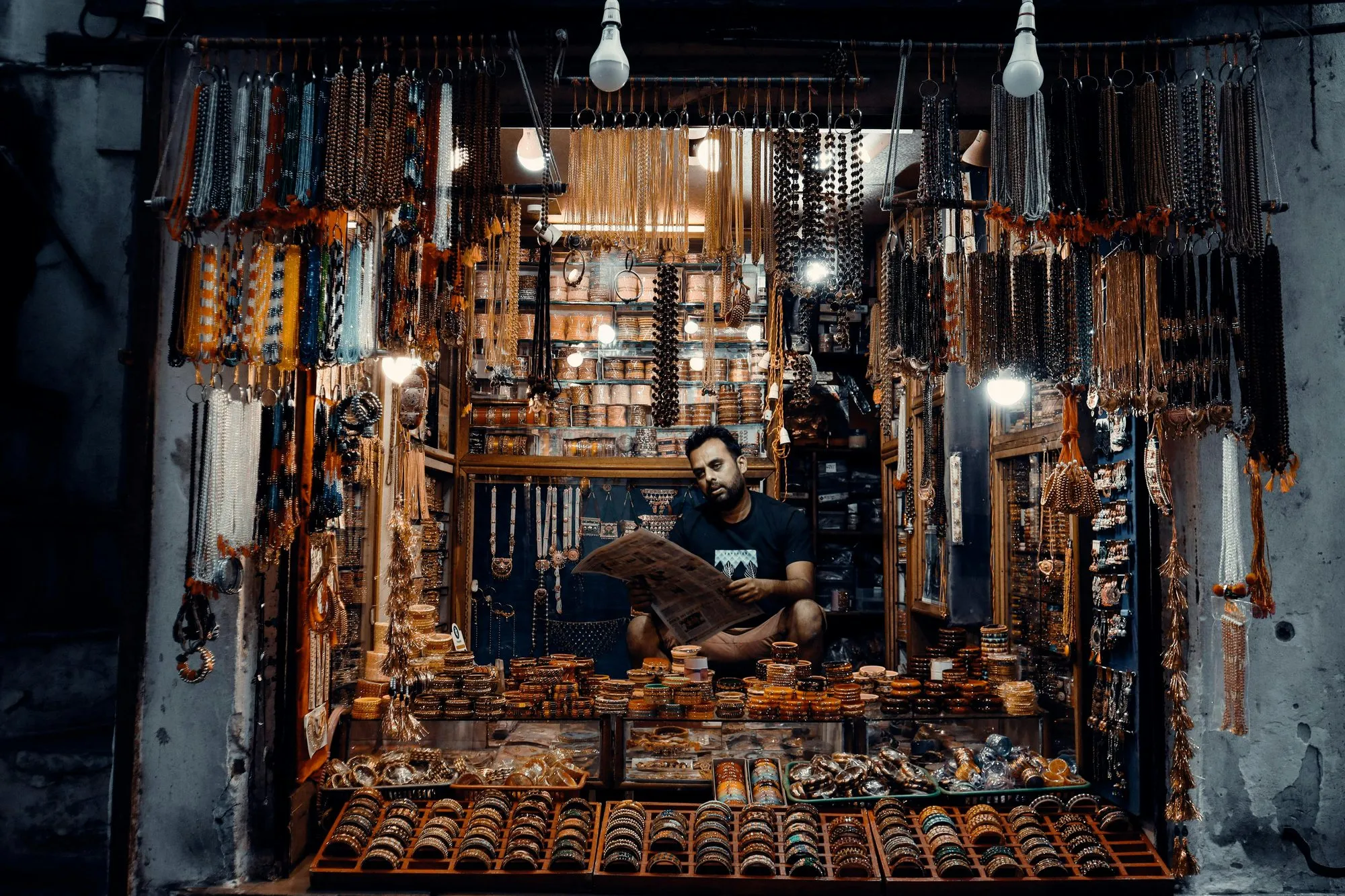 A bangle and bead shop lit at night
