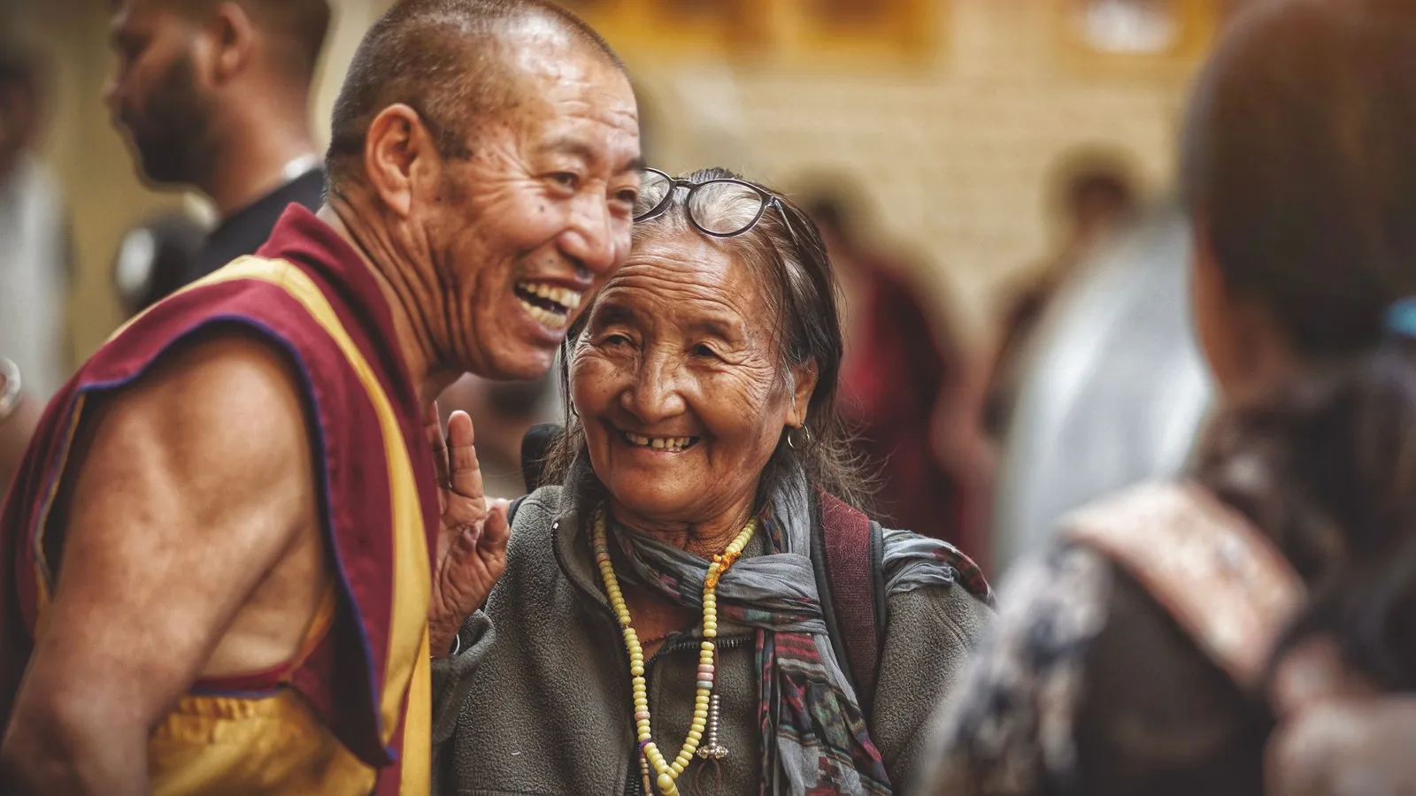 A monk and an elderly woman laughing together, Dharamshala